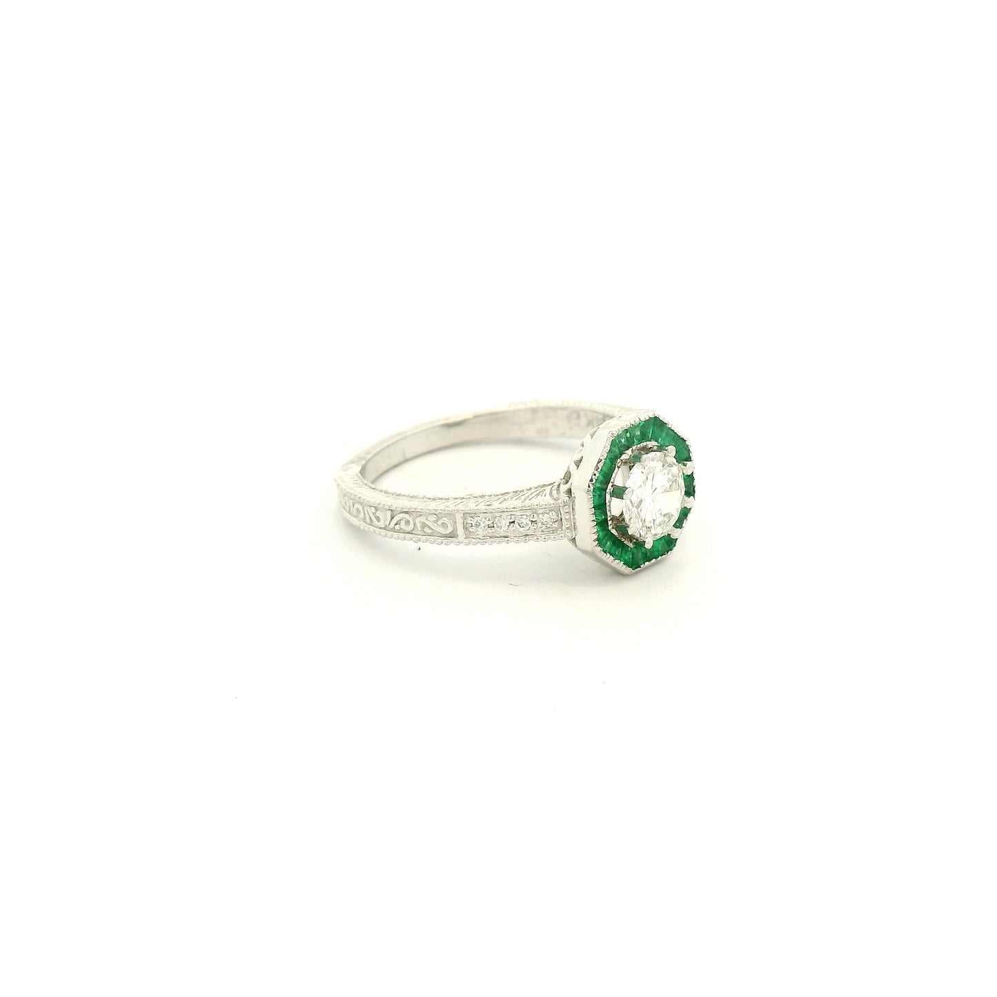 A White Gold Ring with a prong set old mine cut natural Diamond in the center with a halo of baguette cut emeralds at Forever Rox Fine Jewelry, Lake Tahoes Best Jewelry Store