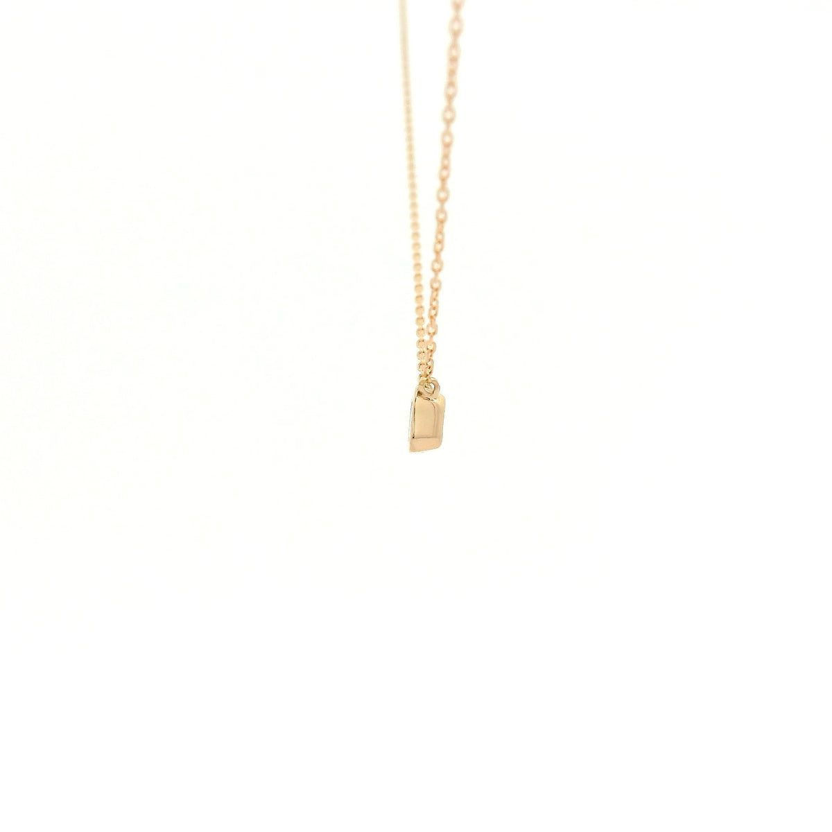 A Rose Gold Pendant with a bezel set emerald cut natural Diamond in the center at Forever Rox Fine Jewelry, Lake Tahoes Best Jewelry Store
