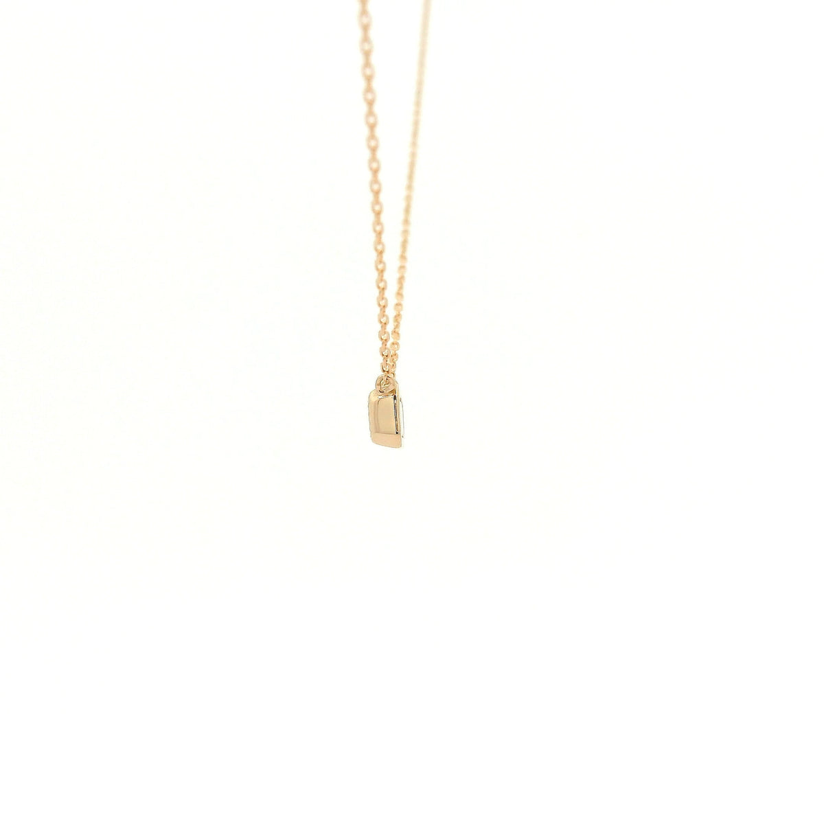 A Rose Gold Pendant with a bezel set emerald cut natural Diamond in the center at Forever Rox Fine Jewelry, Lake Tahoes Best Jewelry Store
