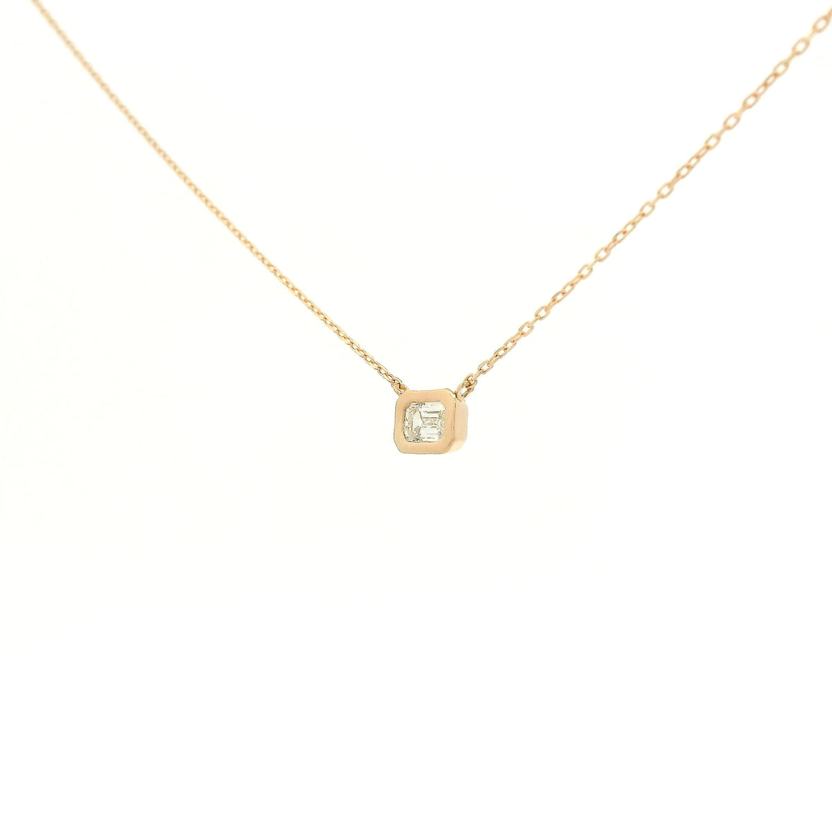 A Rose Gold Pendant with a bezel set emerald cut natural Diamond in the center at Forever Rox Fine Jewelry, Lake Tahoes Best Jewelry Store
