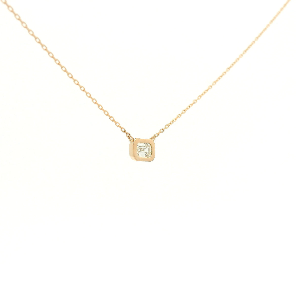 A Rose Gold Pendant with a bezel set emerald cut natural Diamond in the center at Forever Rox Fine Jewelry, Lake Tahoes Best Jewelry Store
