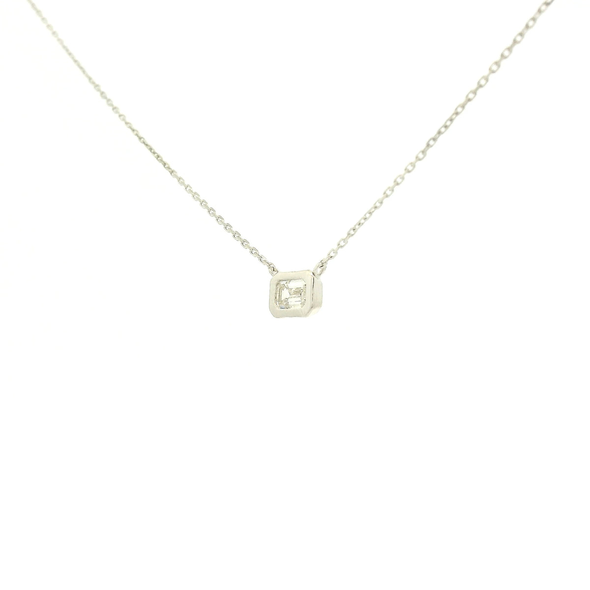 A White Gold Pendant with a bezel set emerald cut natural Diamond in the center at Forever Rox Fine Jewelry, Lake Tahoes Best Jewelry Store
