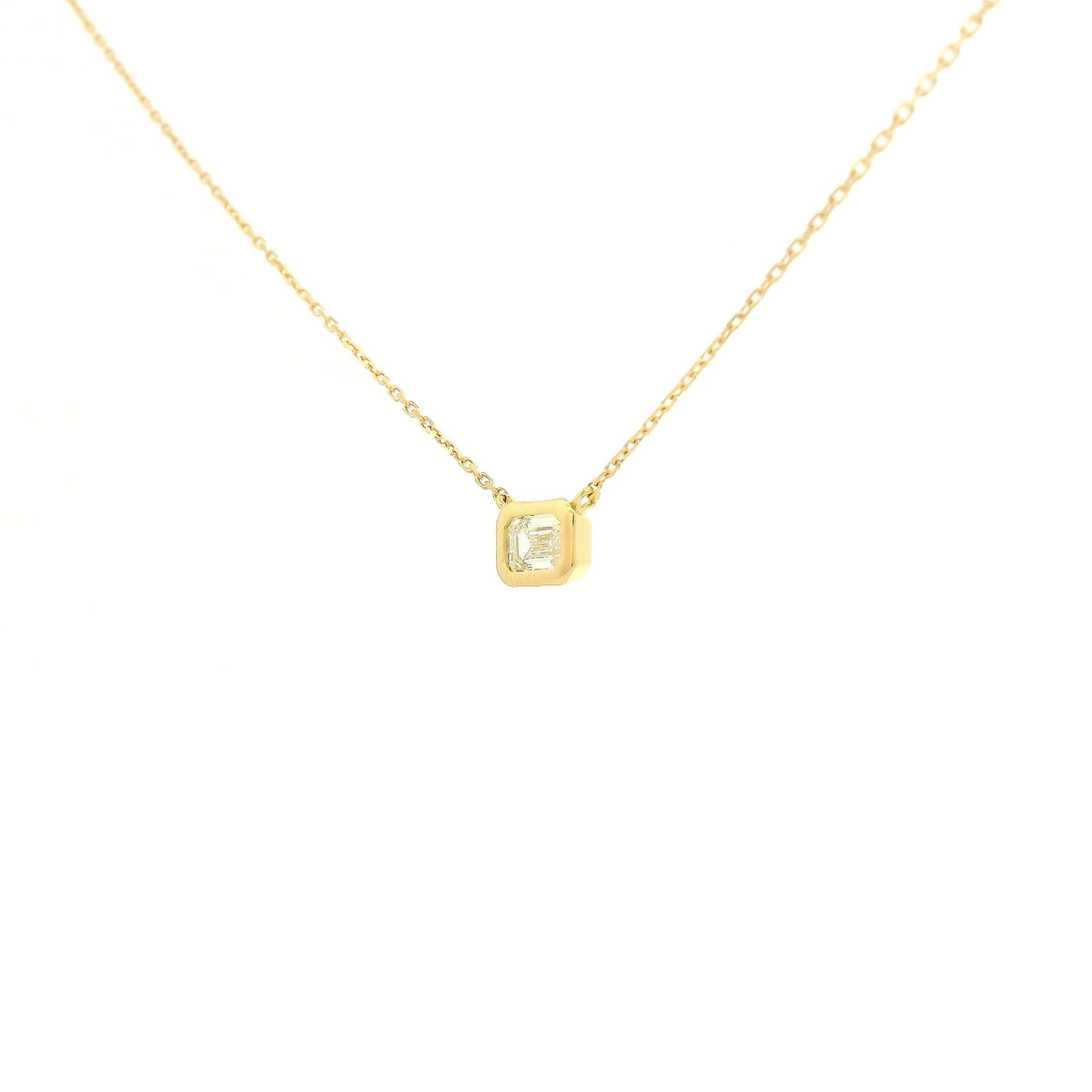 A Yellow Gold Pendant with a bezel set emerald cut natural Diamond in the center at Forever Rox Fine Jewelry, Lake Tahoes Best Jewelry Store
