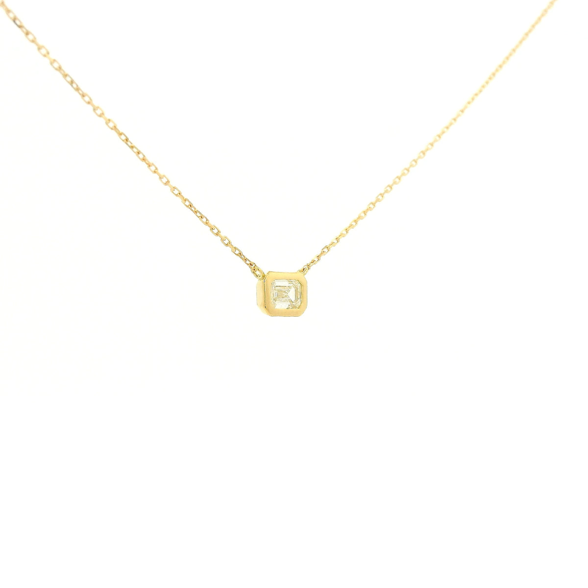 A Yellow Gold Pendant with a bezel set emerald cut natural Diamond in the center at Forever Rox Fine Jewelry, Lake Tahoes Best Jewelry Store
