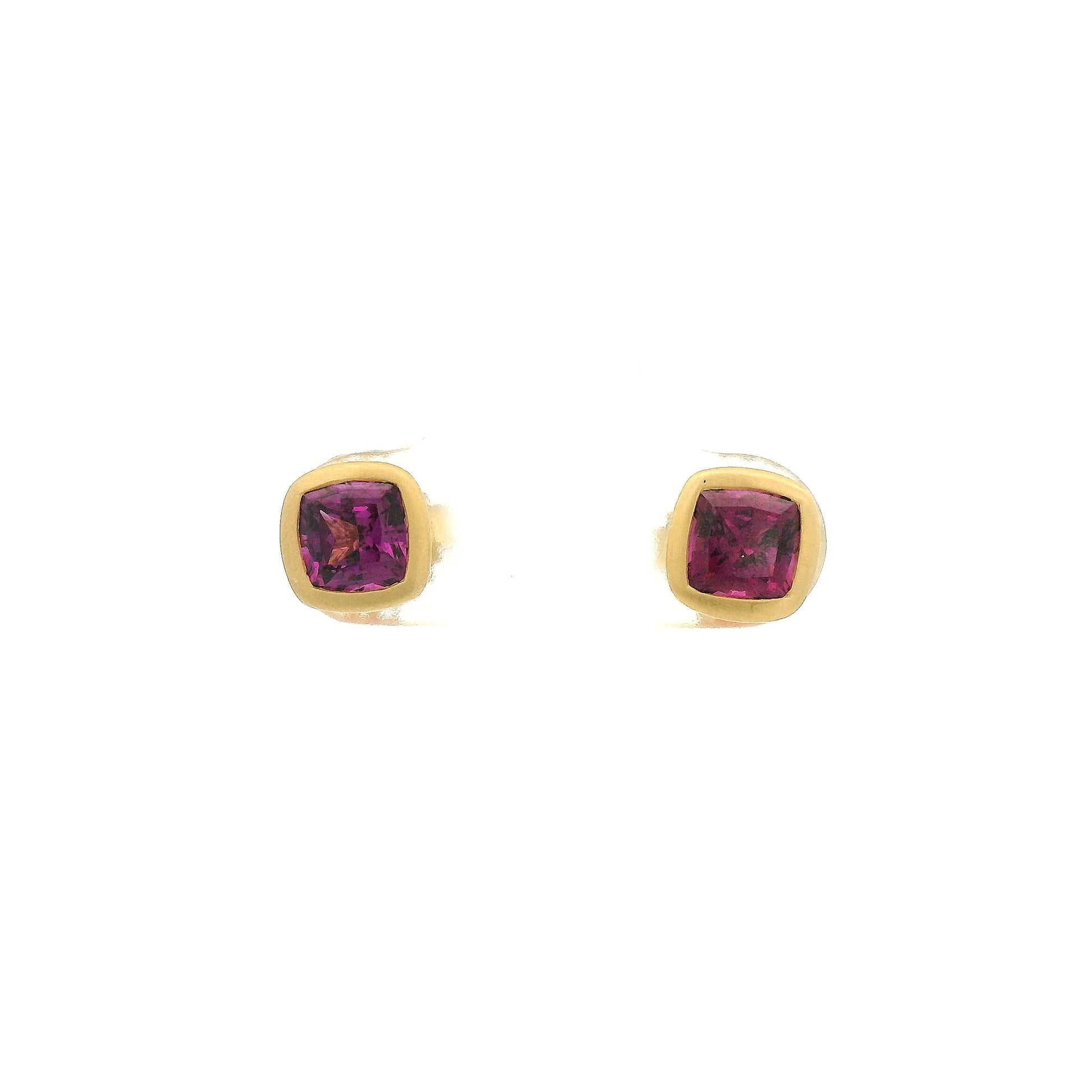 A Pair of Yellow Gold Studs Earrings with bezel set cushion cut natural Purple Garnets in the center at Forever Rox Fine Jewelry, Lake Tahoes Best Jewelry Store