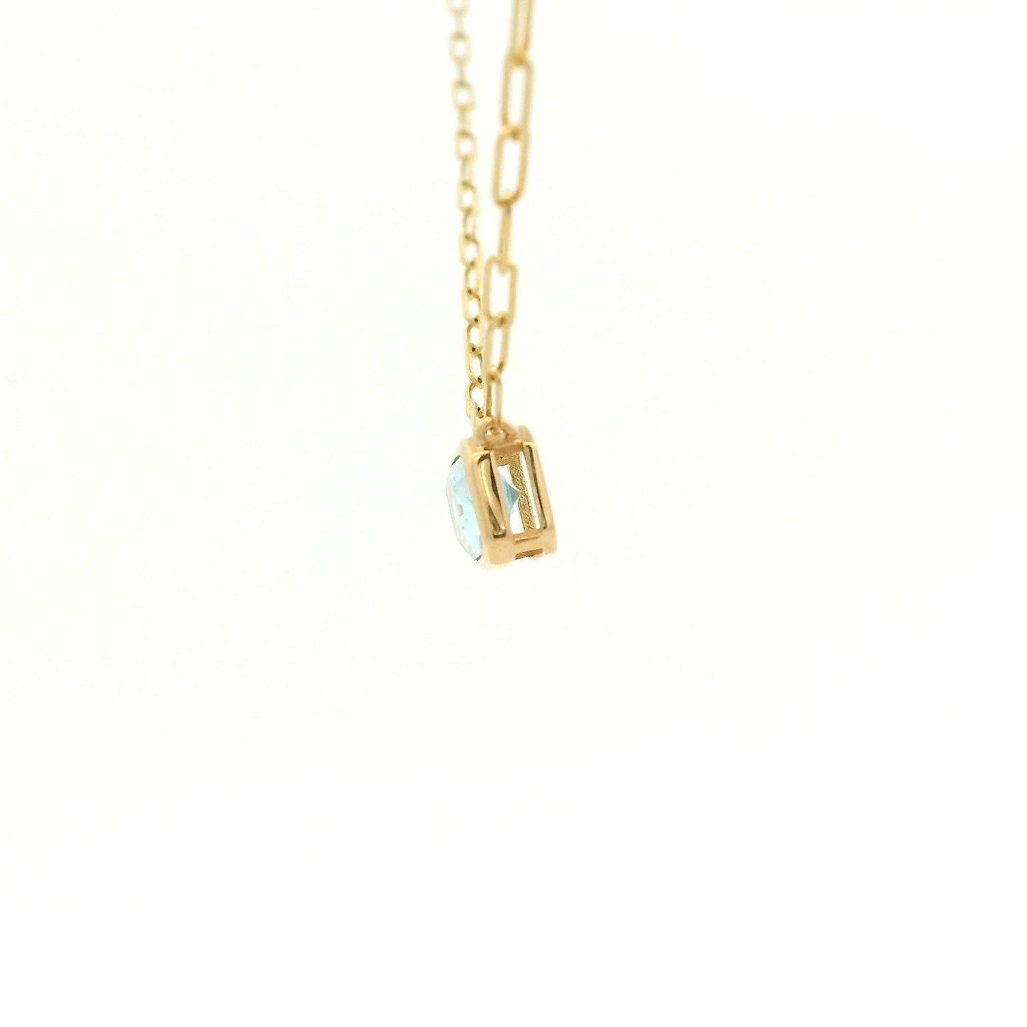 A Yellow Gold Pendant with a bezel set emerald cut natural Swiss Blue Topaz in the center with a paperclip chain attached at Forever Rox Fine Jewelry, Lake Tahoes Best Jewelry Store
