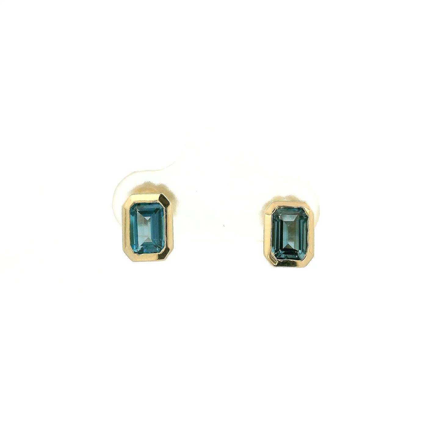 A Pair of Yellow Gold Stud Earrings with bezel set emerald cut natural London BLue Topaz at Forever Rox Fine Jewelry, Lake Tahoes Best Jewelry Store