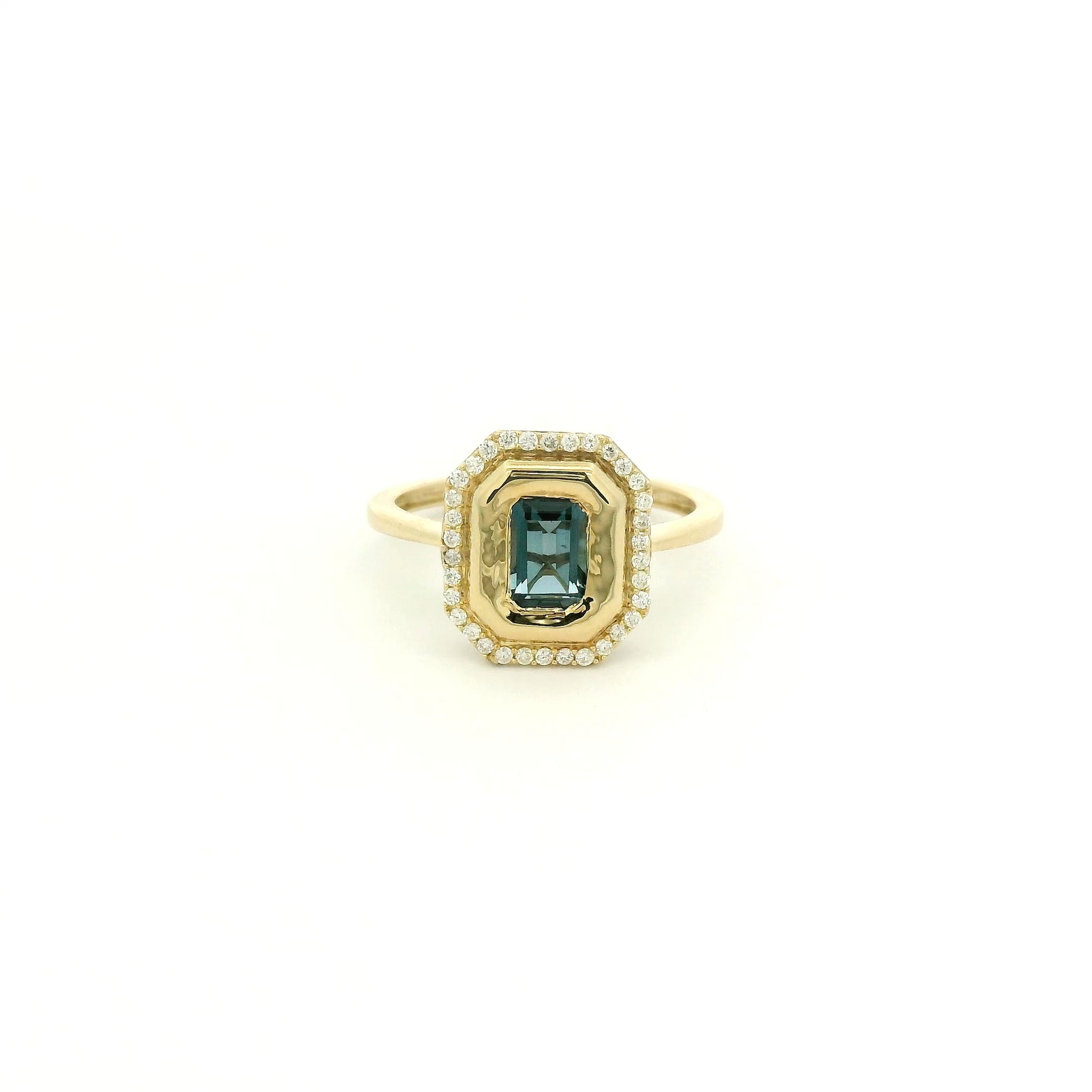 A Yellow Gold Ring with a bezel set emerald cut natural London Blue Topaz in the center with diamonds around the outside at Forever Rox Fine Jewelry, Lake Tahoes Best Jewelry Store
