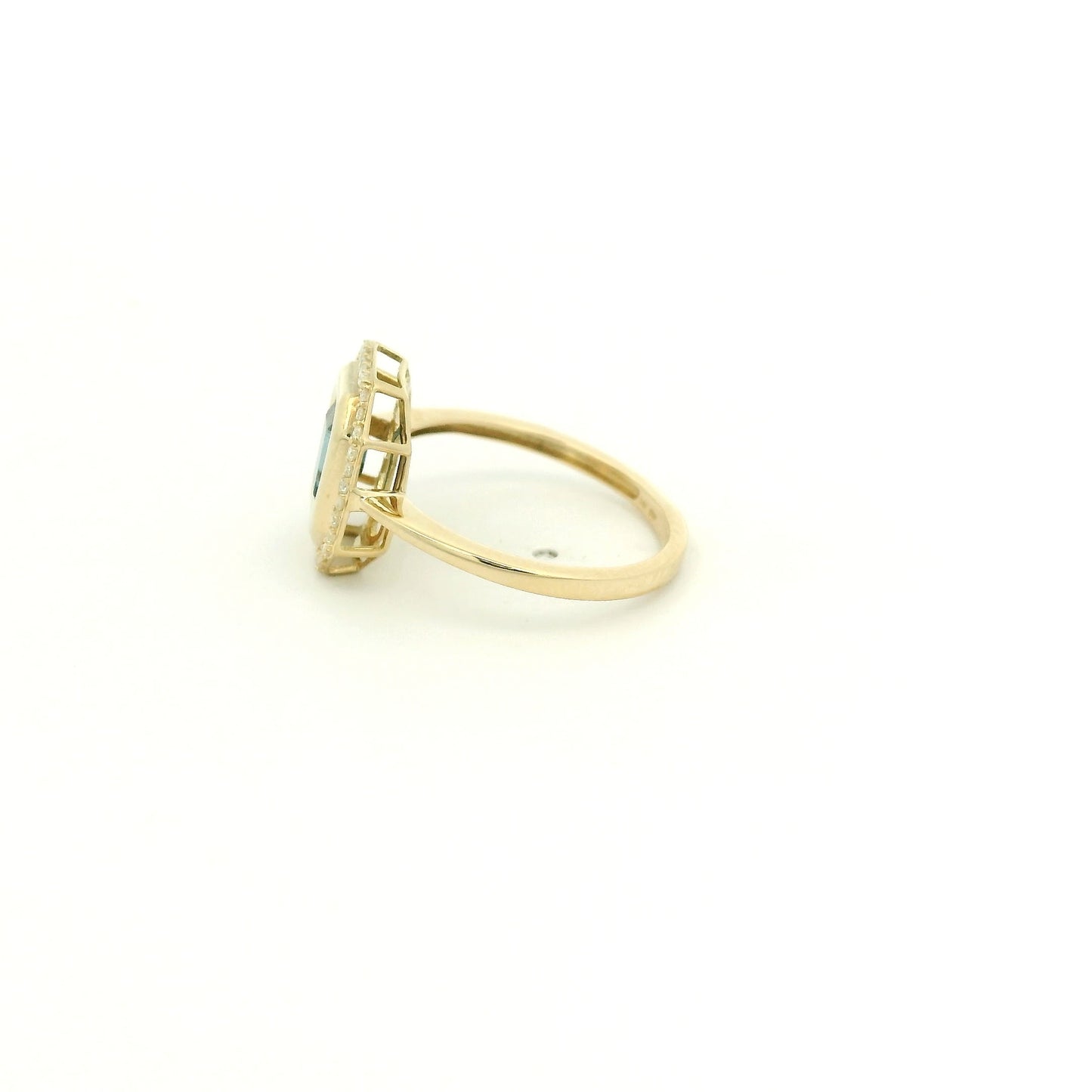 A Yellow Gold Ring with a bezel set emerald cut natural London Blue Topaz in the center with diamonds around the outside at Forever Rox Fine Jewelry, Lake Tahoes Best Jewelry Store
