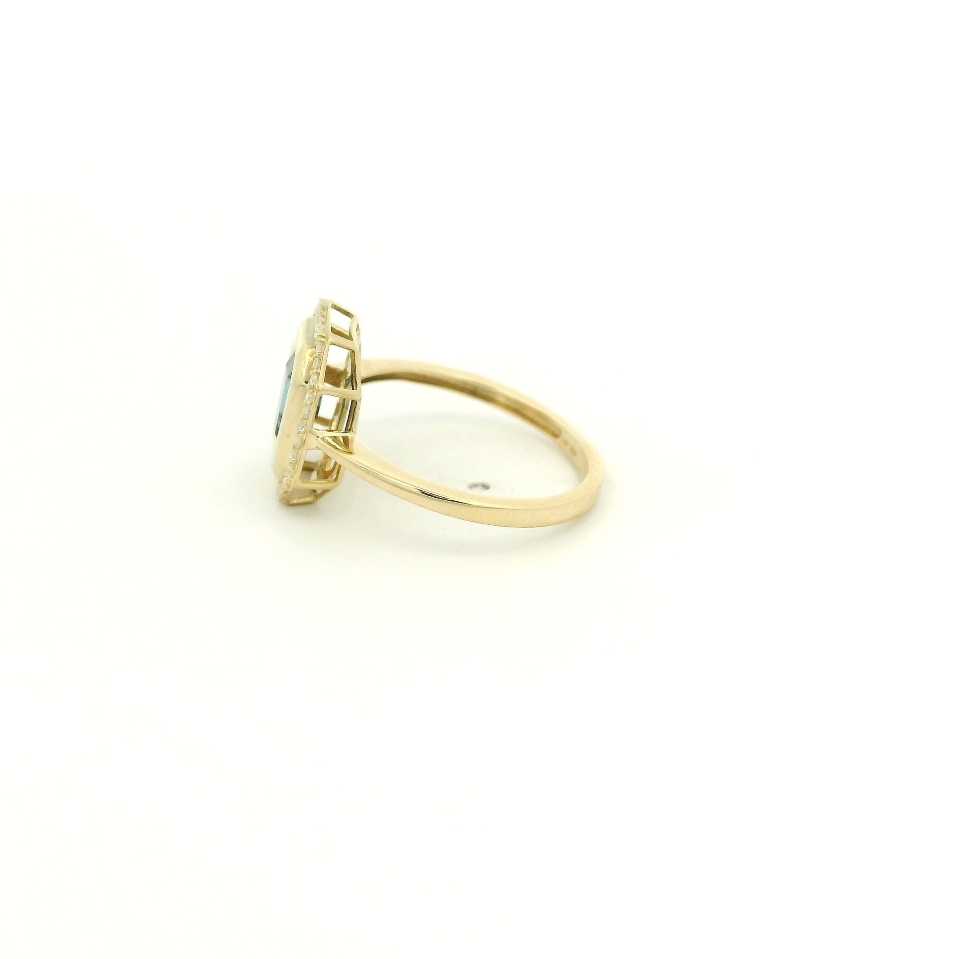 A Yellow Gold Ring with a bezel set emerald cut natural London Blue Topaz in the center with diamonds around the outside at Forever Rox Fine Jewelry, Lake Tahoes Best Jewelry Store
