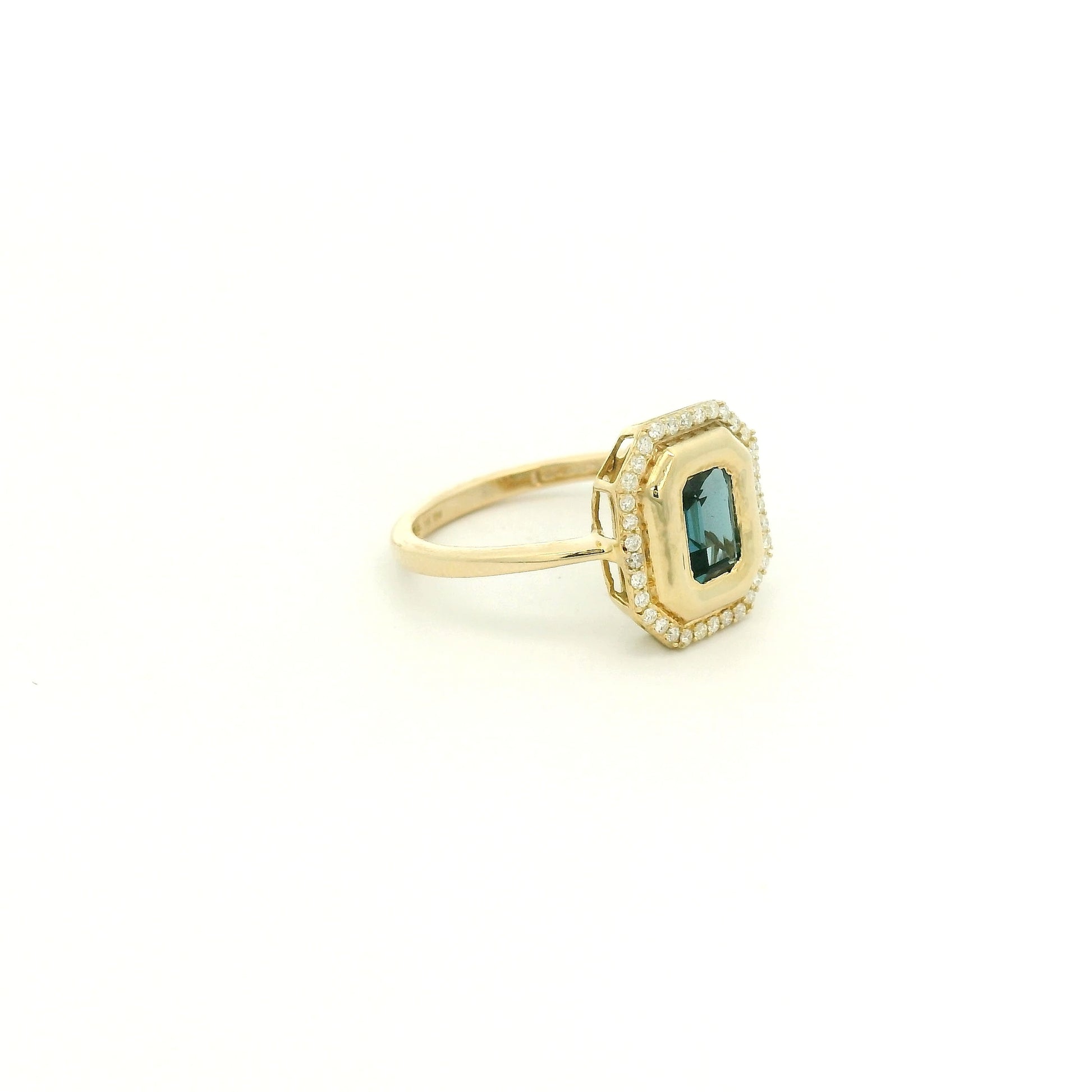 A Yellow Gold Ring with a bezel set emerald cut natural London Blue Topaz in the center with diamonds around the outside at Forever Rox Fine Jewelry, Lake Tahoes Best Jewelry Store
