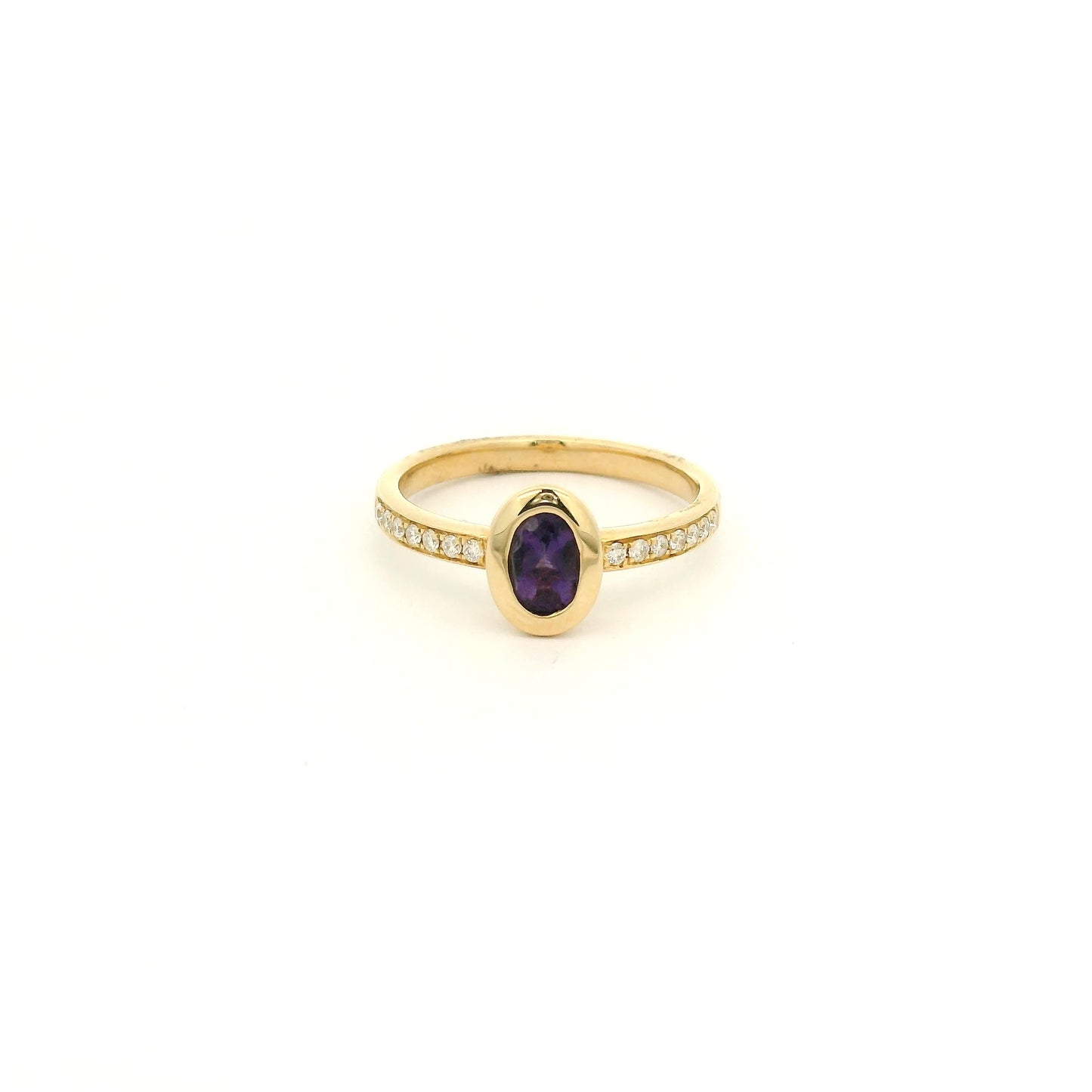 A Yellow Gold Ring with a bezel set oval cut natural Amethyst in the center with diamonds down the shank at Forever Rox Fine Jewelry, Lake Tahoes Best Jewelry Store