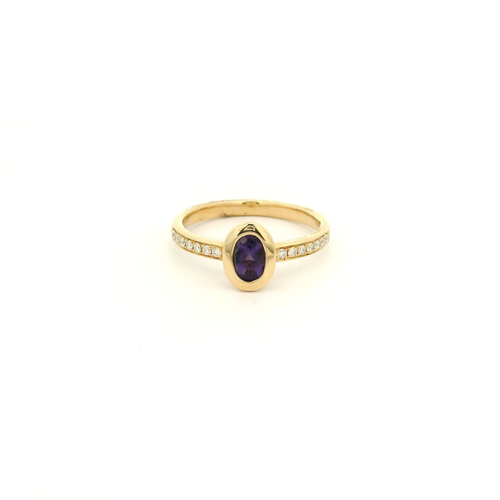 A Yellow Gold Ring with a bezel set oval cut natural Amethyst in the center with diamonds down the shank at Forever Rox Fine Jewelry, Lake Tahoes Best Jewelry Store