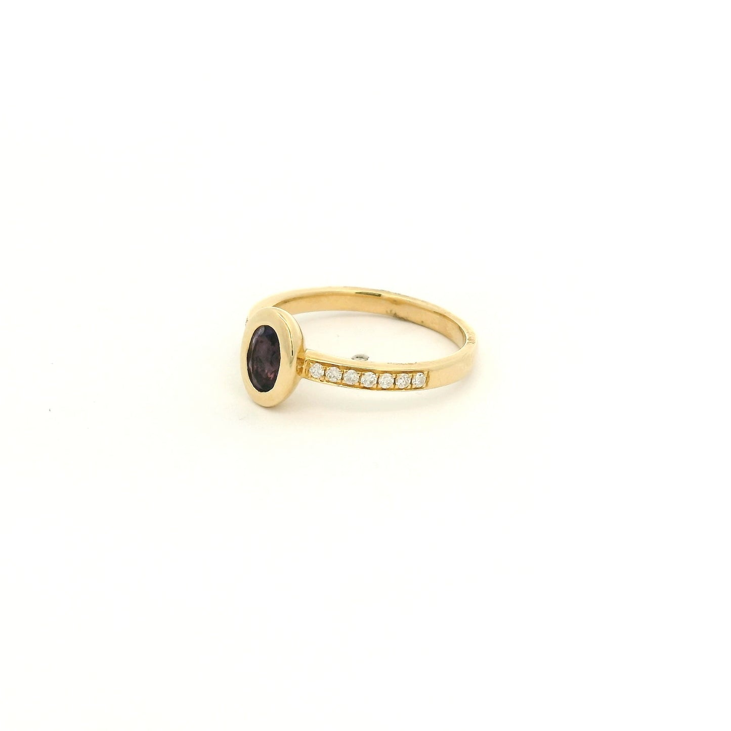 A Yellow Gold Ring with a bezel set oval cut natural Amethyst in the center with diamonds down the shank at Forever Rox Fine Jewelry, Lake Tahoes Best Jewelry Store