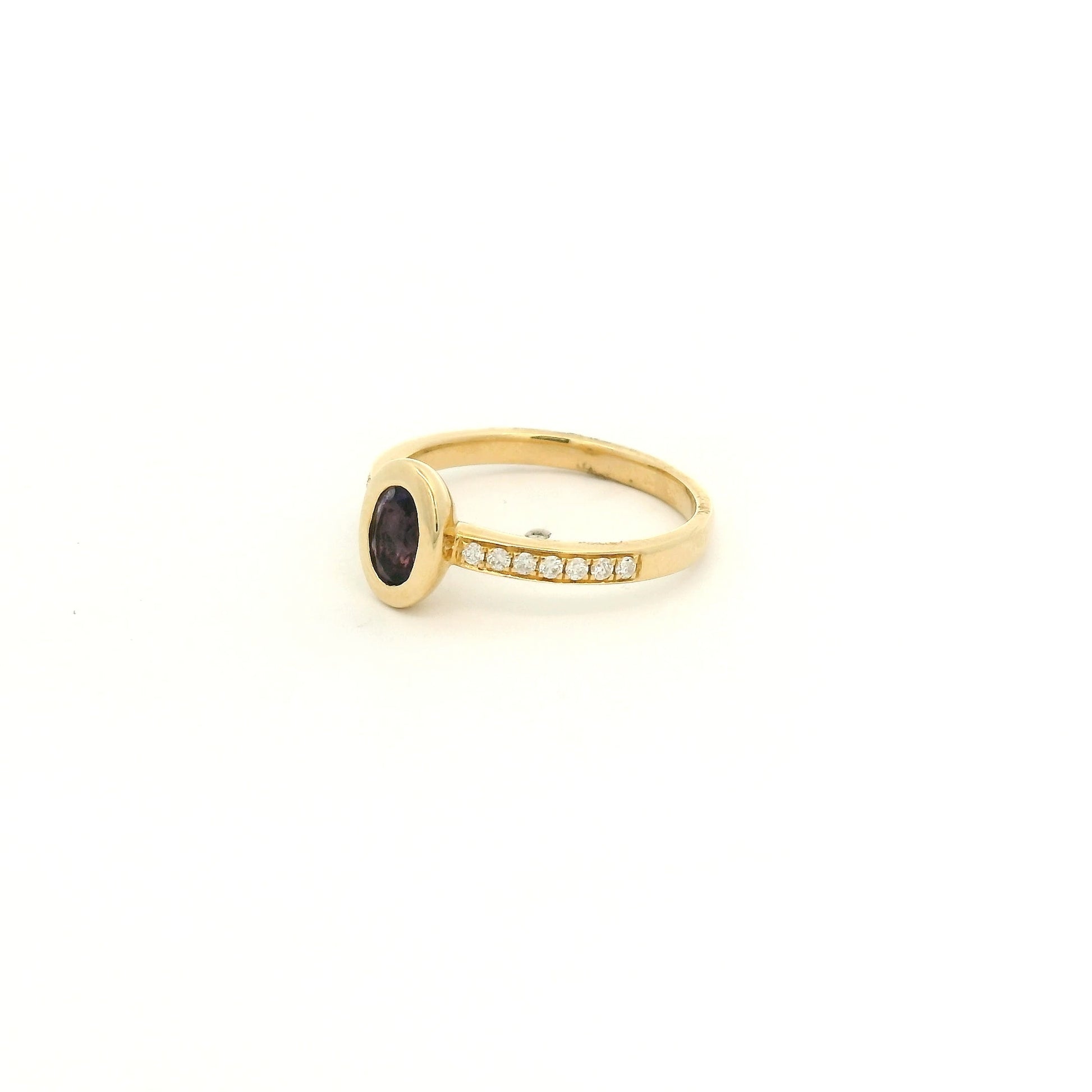A Yellow Gold Ring with a bezel set oval cut natural Amethyst in the center with diamonds down the shank at Forever Rox Fine Jewelry, Lake Tahoes Best Jewelry Store
