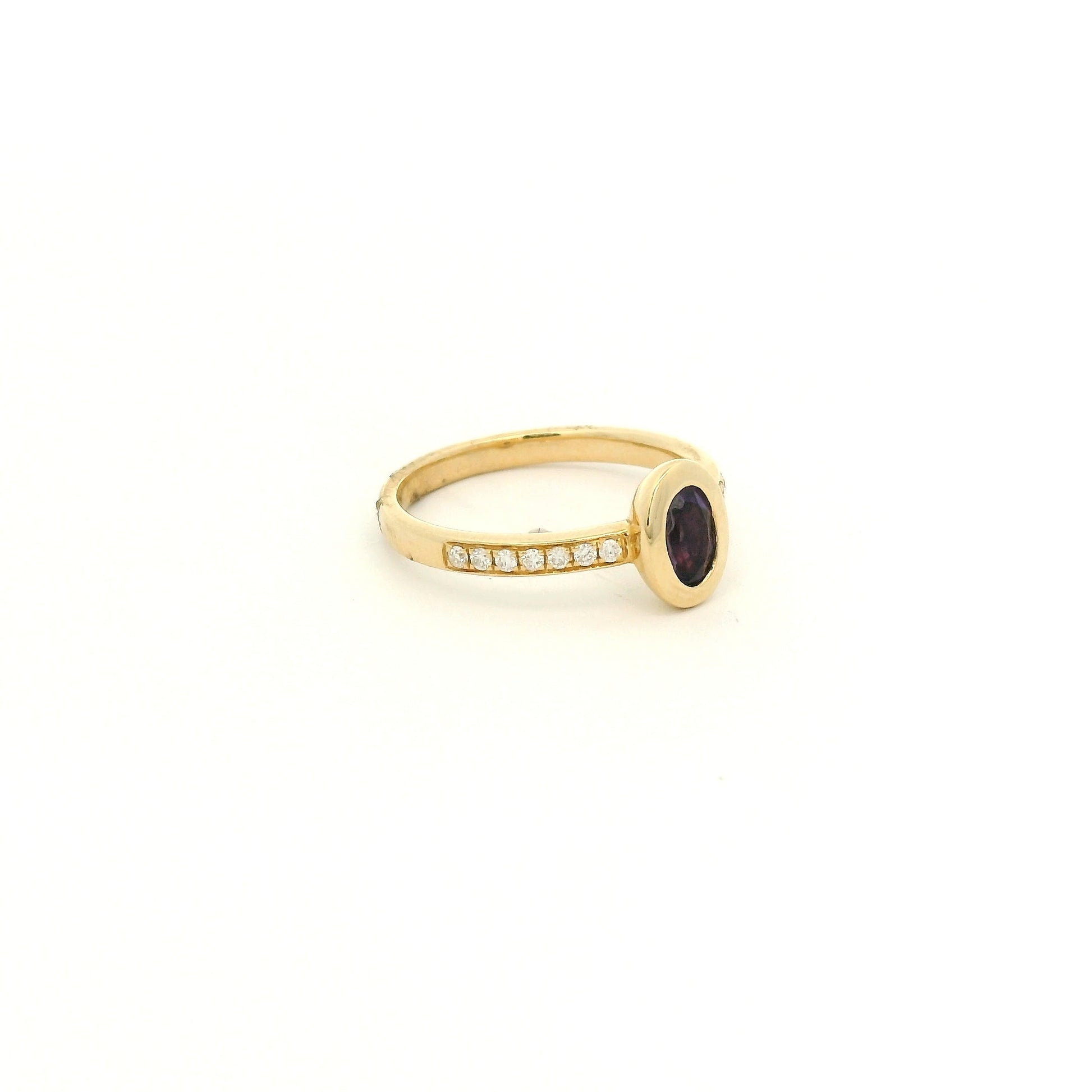 A Yellow Gold Ring with a bezel set oval cut natural Amethyst in the center with diamonds down the shank at Forever Rox Fine Jewelry, Lake Tahoes Best Jewelry Store