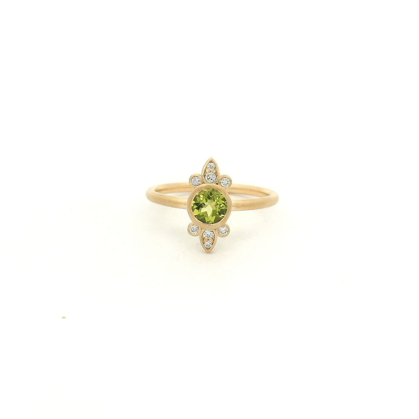 A Yellow Gold Ring with a bezel set round cut natural Peridot in the center with diamond bursts at Forever Rox Fine Jewelry, Lake Tahoes Best Jewelry Store

