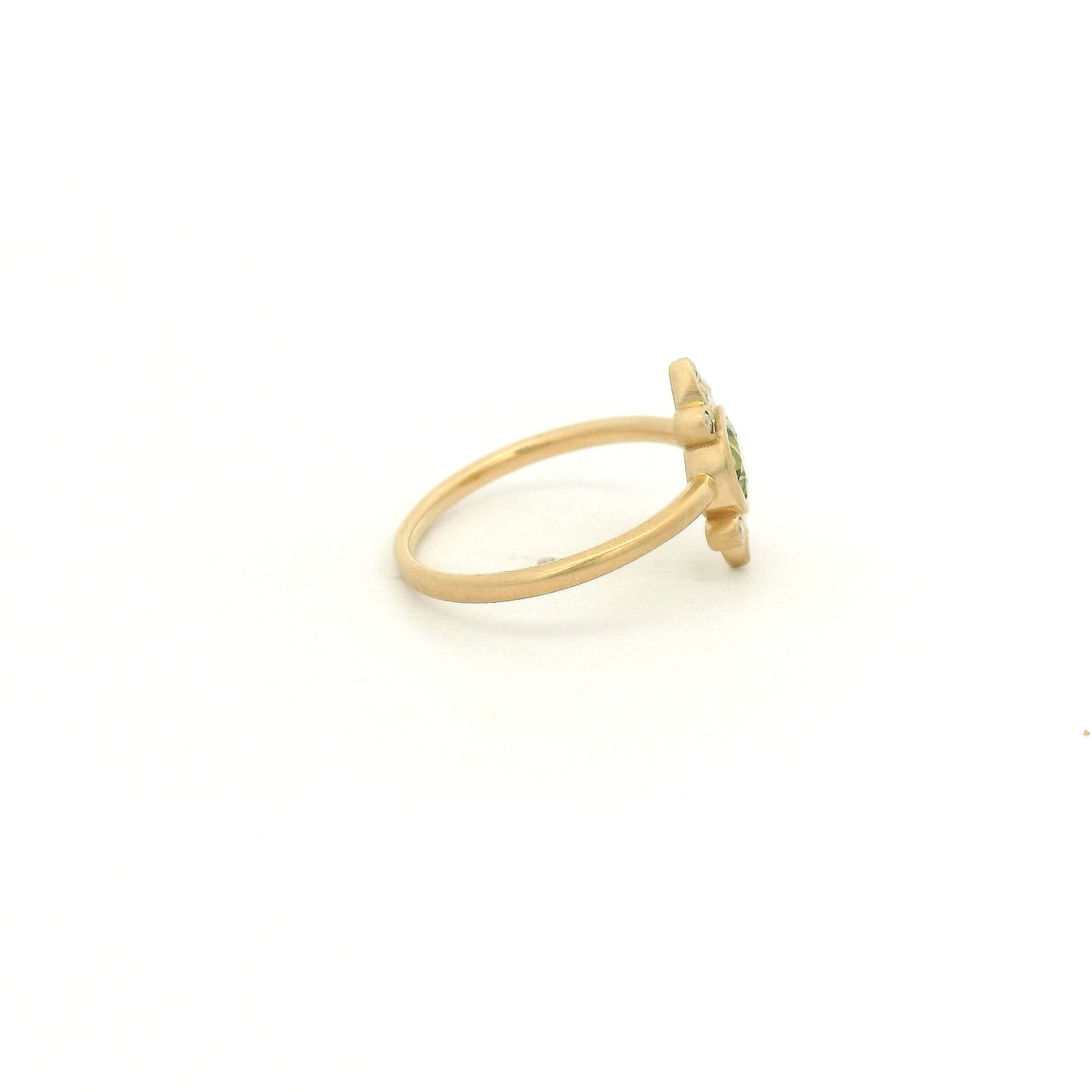 A Yellow Gold Ring with a bezel set round cut natural Peridot in the center with diamond bursts at Forever Rox Fine Jewelry, Lake Tahoes Best Jewelry Store
