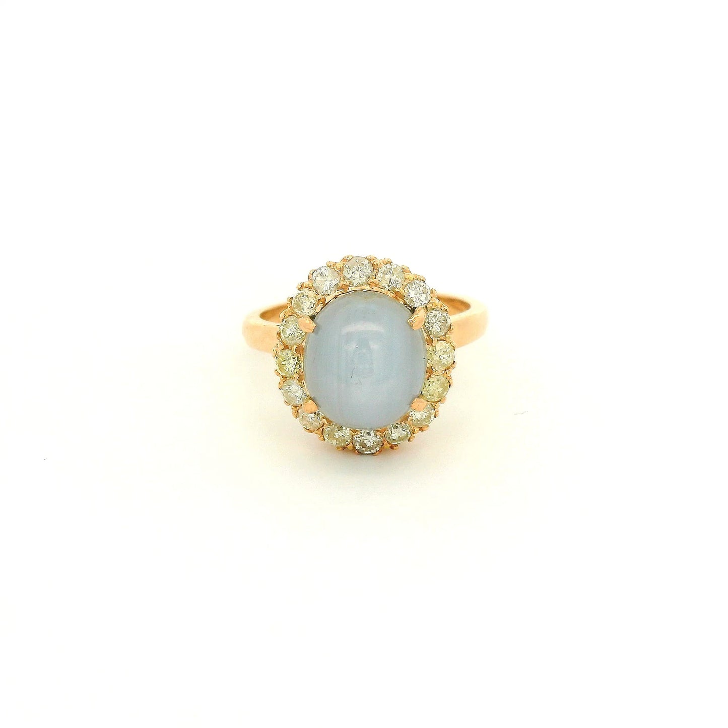 A Rose Gold Ring with a prong set cabochon cut natural Star Sapphire in the center with a diamond halo at Forever Rox Fine Jewelry, Lake Tahoes Best Jewelry Store
