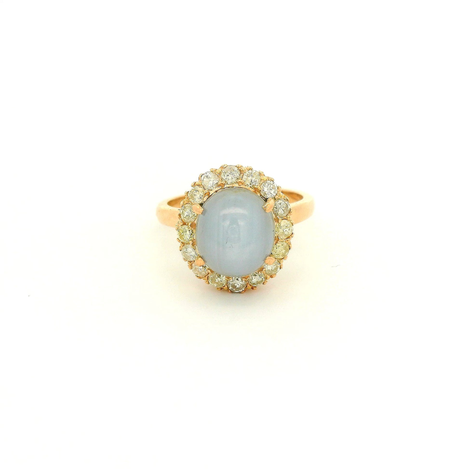 A Rose Gold Ring with a prong set cabochon cut natural Star Sapphire in the center with a diamond halo at Forever Rox Fine Jewelry, Lake Tahoes Best Jewelry Store

