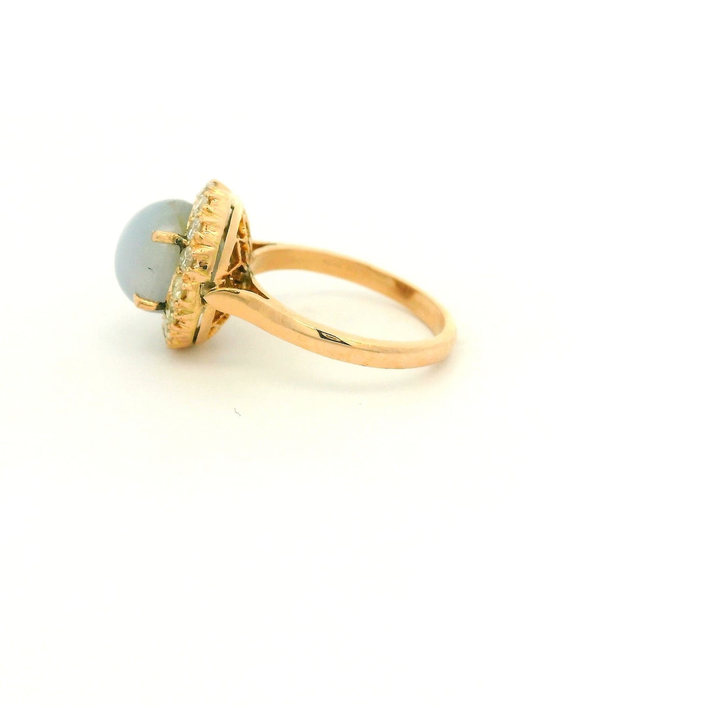 A Rose Gold Ring with a prong set cabochon cut natural Star Sapphire in the center with a diamond halo at Forever Rox Fine Jewelry, Lake Tahoes Best Jewelry Store