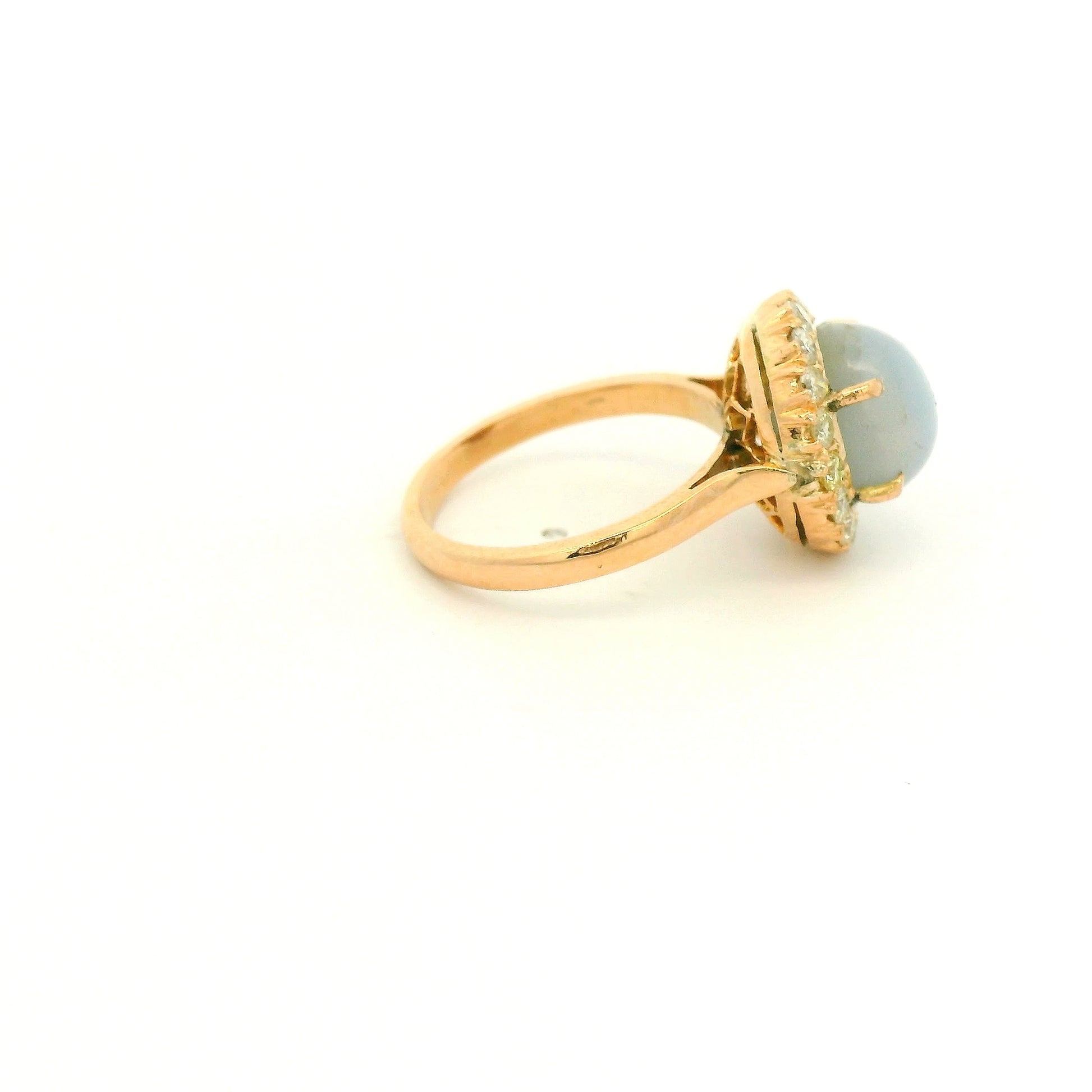 A Rose Gold Ring with a prong set cabochon cut natural Star Sapphire in the center with a diamond halo at Forever Rox Fine Jewelry, Lake Tahoes Best Jewelry Store