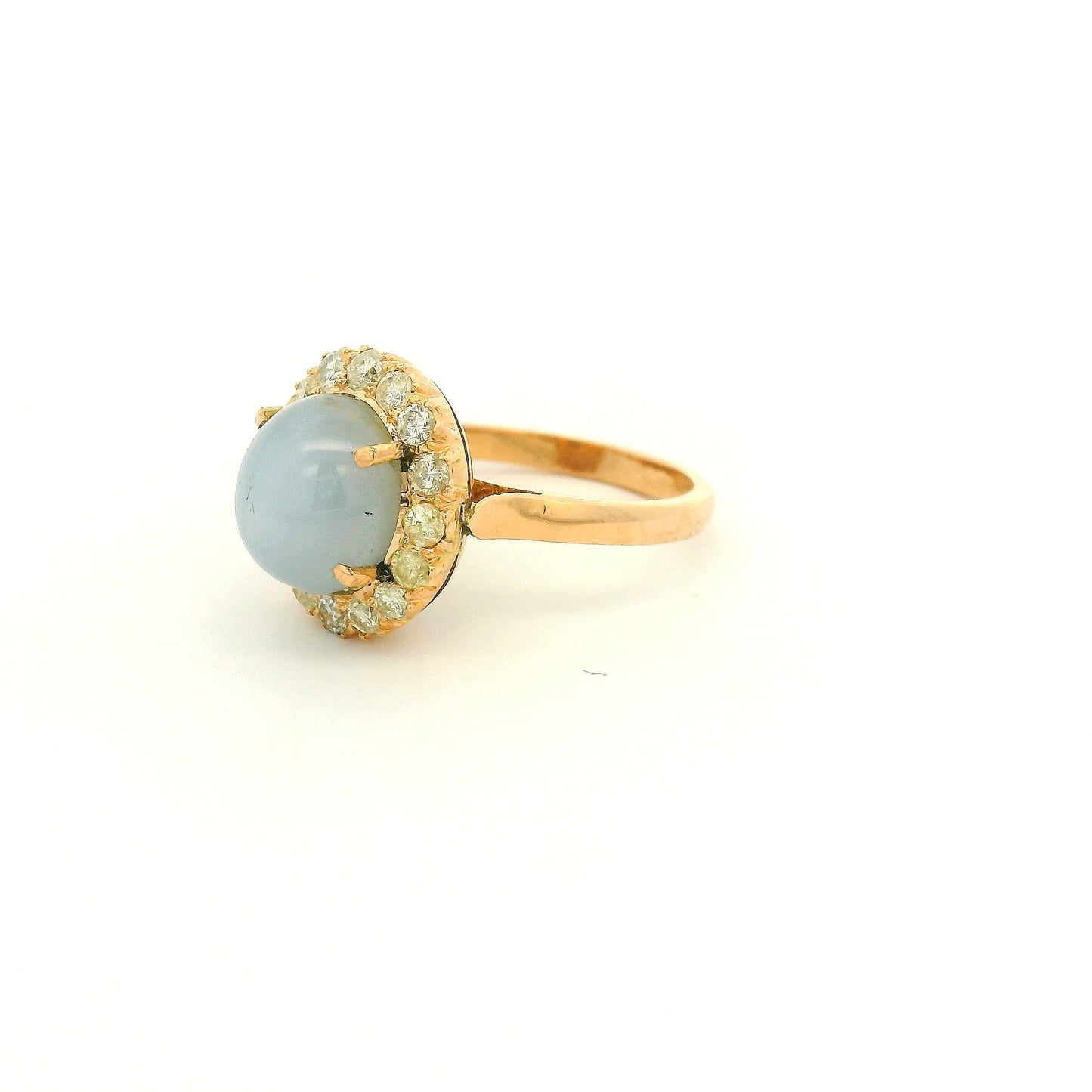 A Rose Gold Ring with a prong set cabochon cut natural Star Sapphire in the center with a diamond halo at Forever Rox Fine Jewelry, Lake Tahoes Best Jewelry Store
