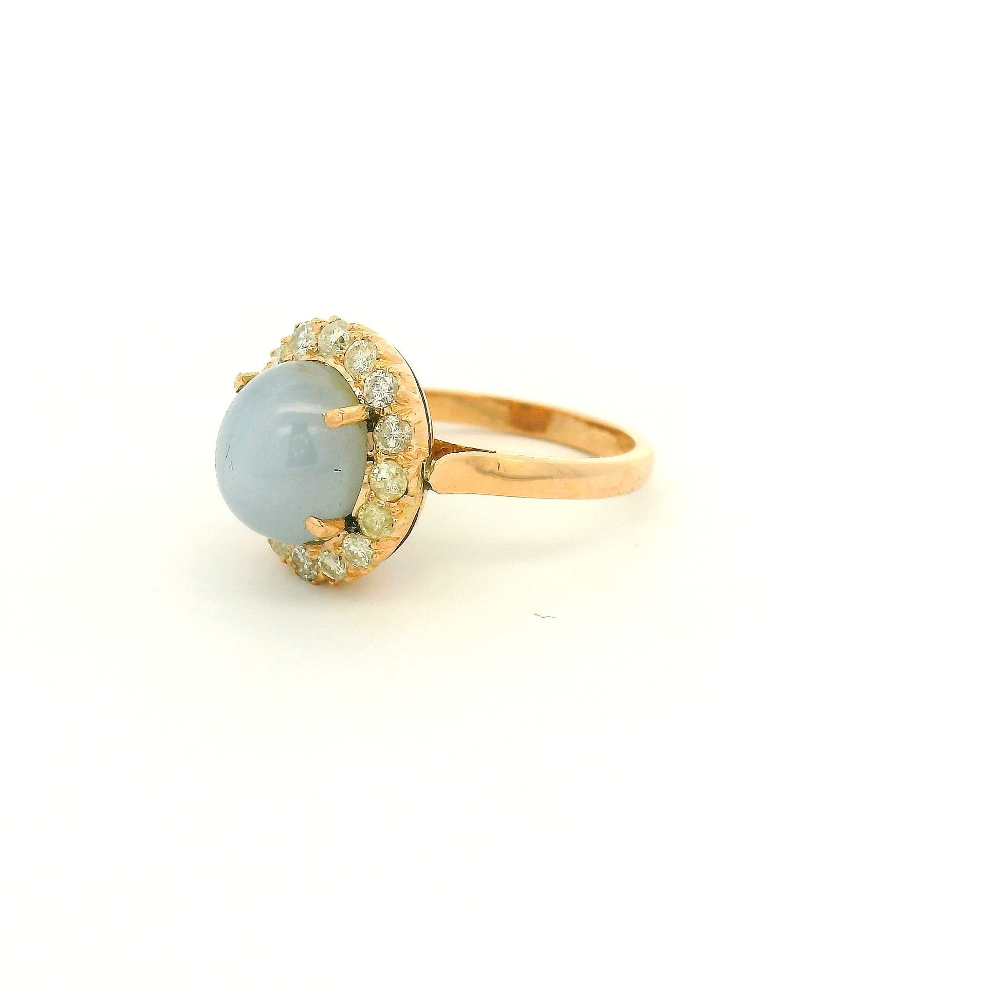 A Rose Gold Ring with a prong set cabochon cut natural Star Sapphire in the center with a diamond halo at Forever Rox Fine Jewelry, Lake Tahoes Best Jewelry Store