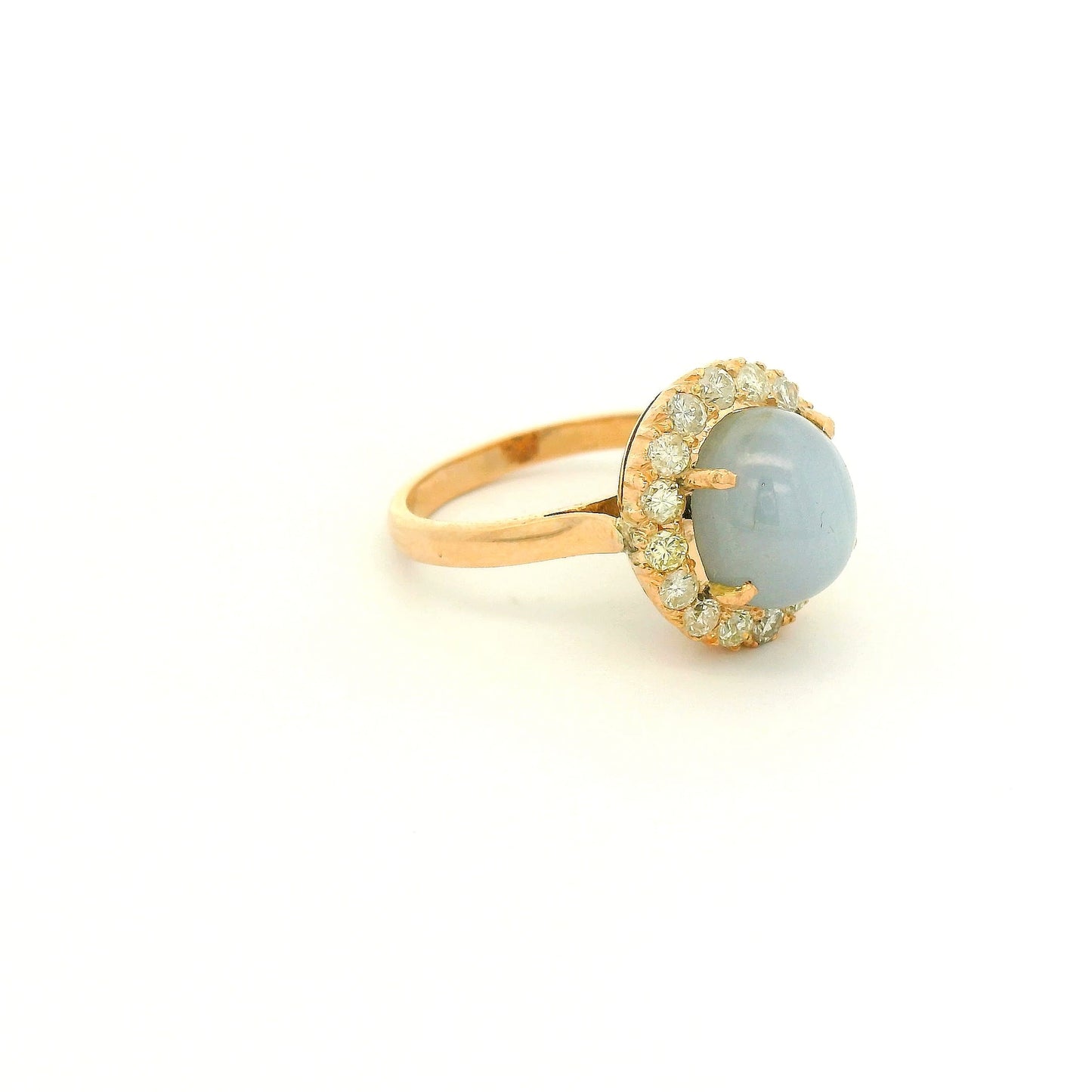A Rose Gold Ring with a prong set cabochon cut natural Star Sapphire in the center with a diamond halo at Forever Rox Fine Jewelry, Lake Tahoes Best Jewelry Store