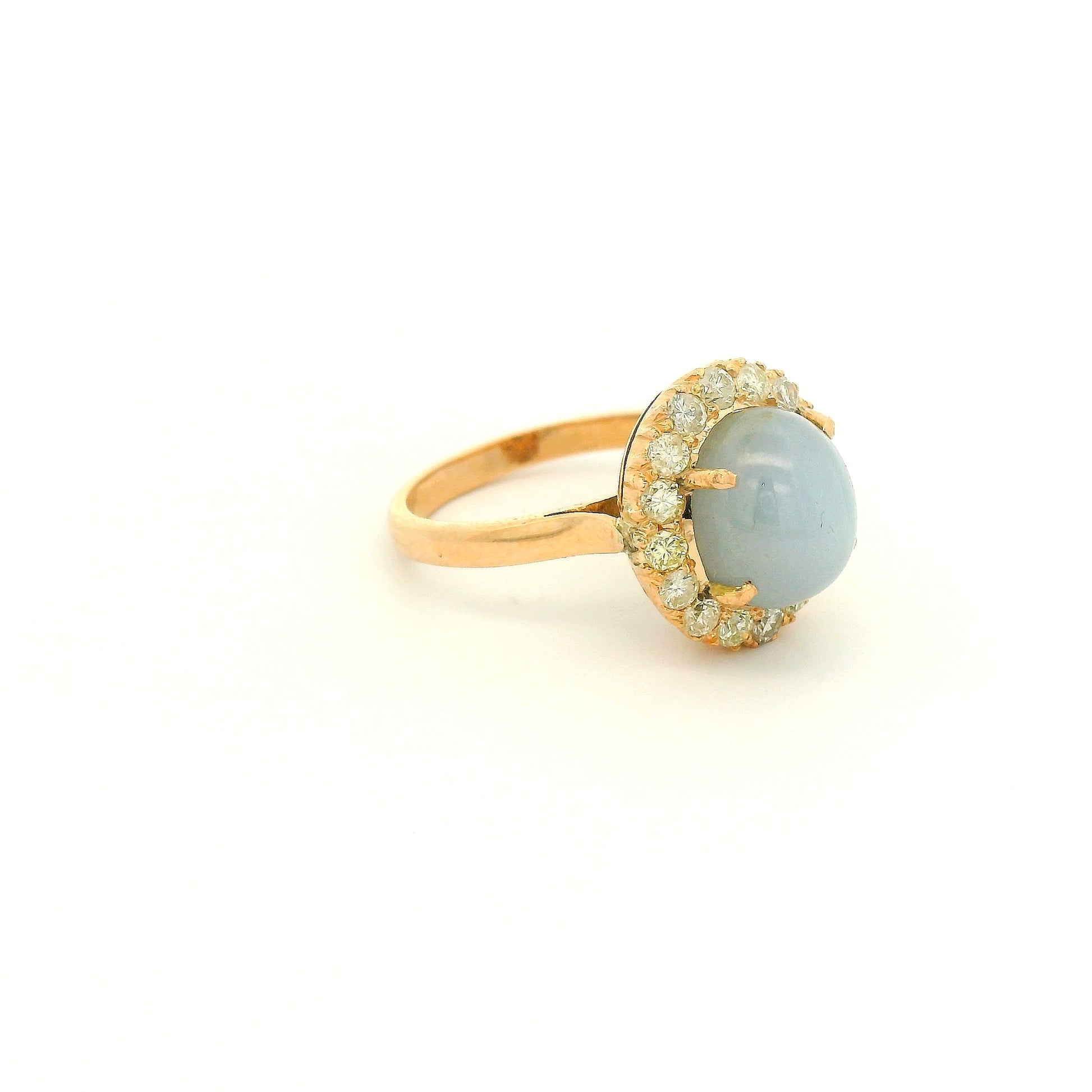 A Rose Gold Ring with a prong set cabochon cut natural Star Sapphire in the center with a diamond halo at Forever Rox Fine Jewelry, Lake Tahoes Best Jewelry Store