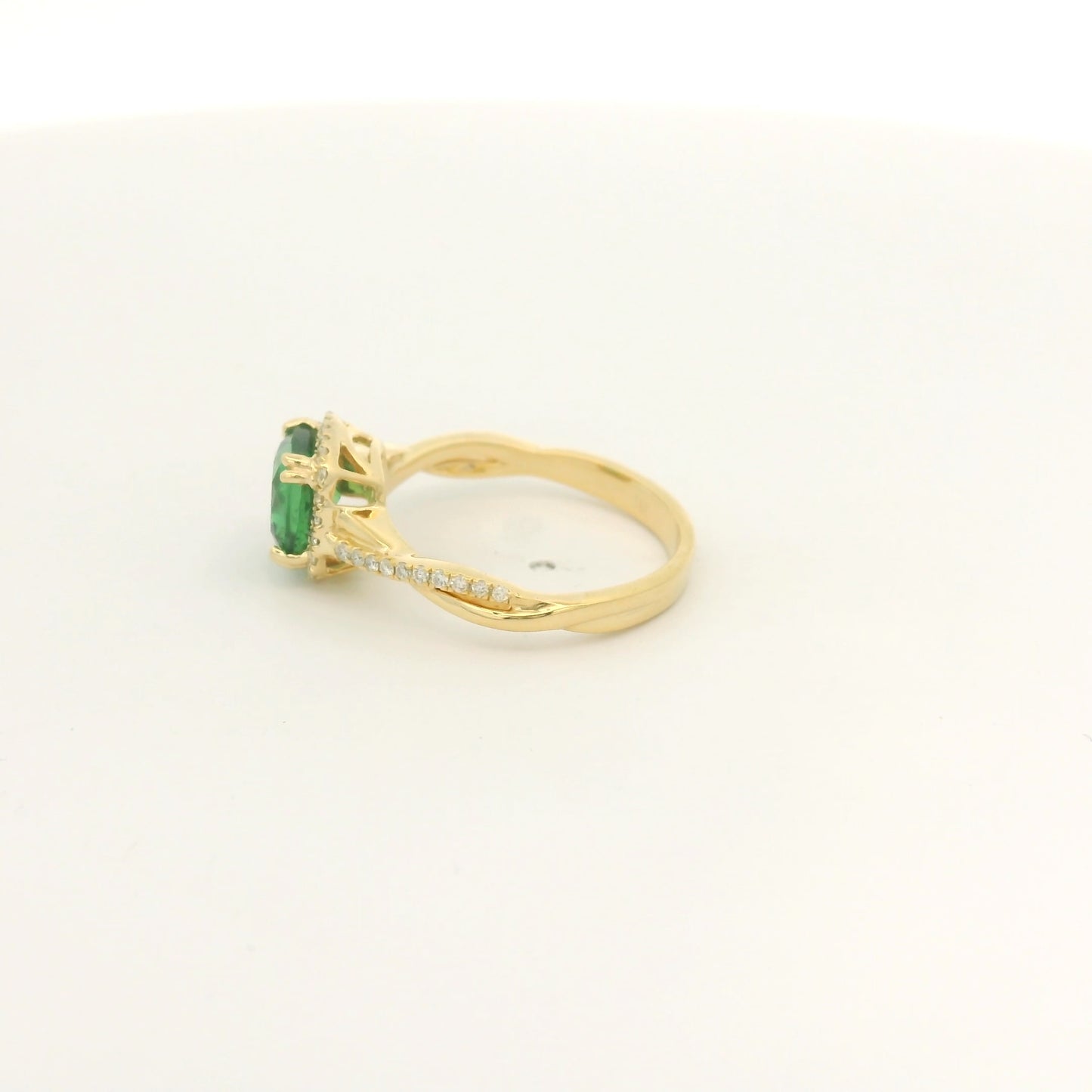 A Yellow Gold Crossover Ring with a prong set cushion cut natural Tsavorite in the center with a halo of diamonds and diamonds down shank at Forever Rox Fine Jewelry, Lake Tahoes Best Jewelry Store