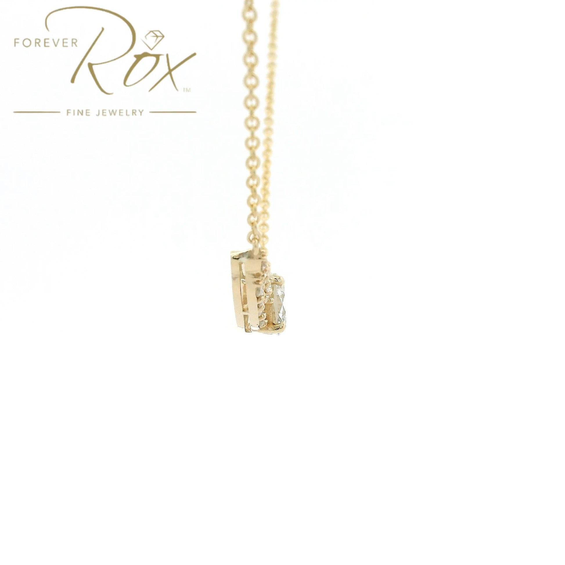 This custom pendant showcases a breathtaking 1.85 carat round brilliant-cut diamond at its center, gracefully set within a flowing curved design crafted in 14k yellow gold. Accented by a cascade of smaller diamonds along each side, the pendant creates a beautiful balance of brilliance and elegance. Designed to highlight the exceptional center stone, this timeless custom piece offers a refined look with sparkle from every angle.