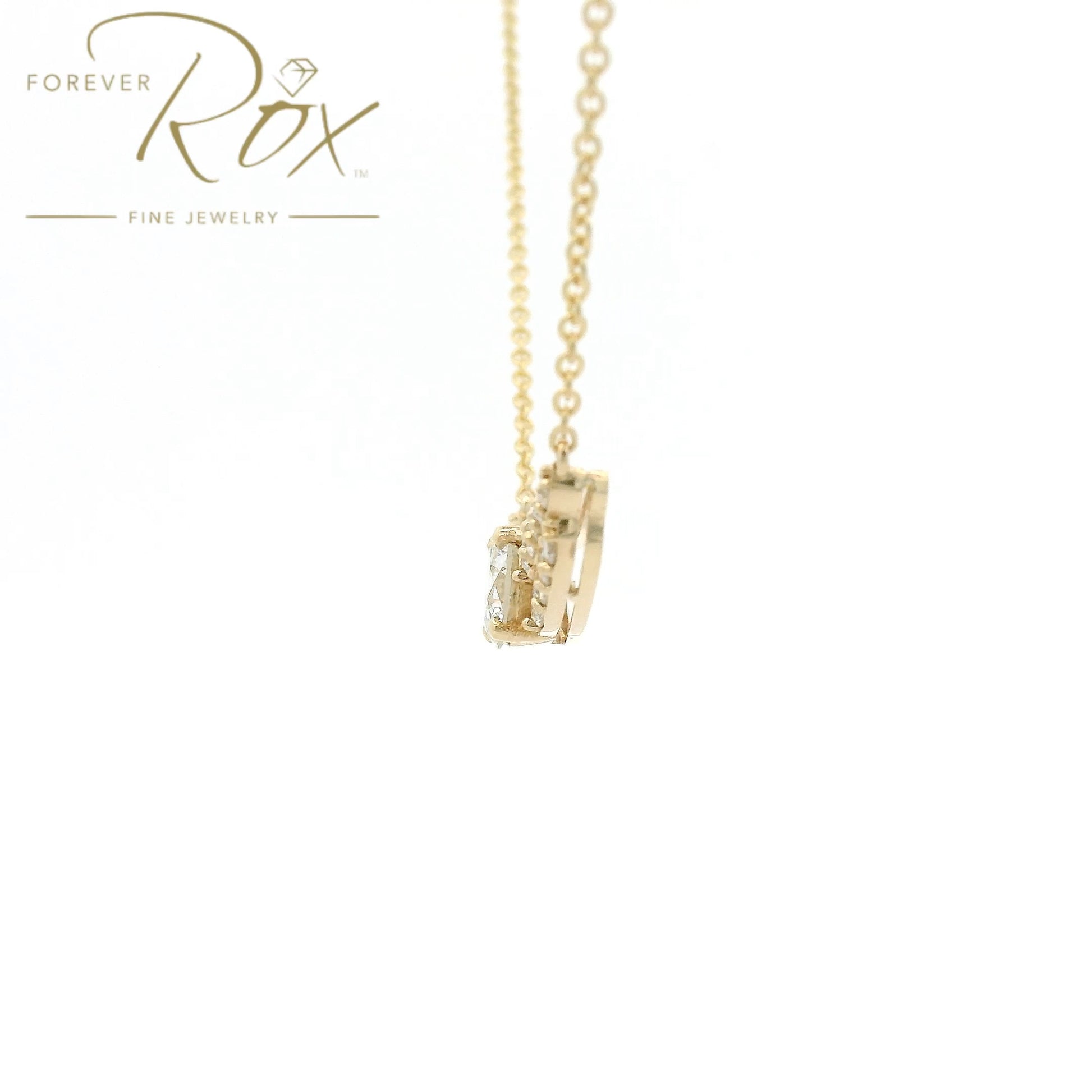 This custom pendant showcases a breathtaking 1.85 carat round brilliant-cut diamond at its center, gracefully set within a flowing curved design crafted in 14k yellow gold. Accented by a cascade of smaller diamonds along each side, the pendant creates a beautiful balance of brilliance and elegance. Designed to highlight the exceptional center stone, this timeless custom piece offers a refined look with sparkle from every angle.
