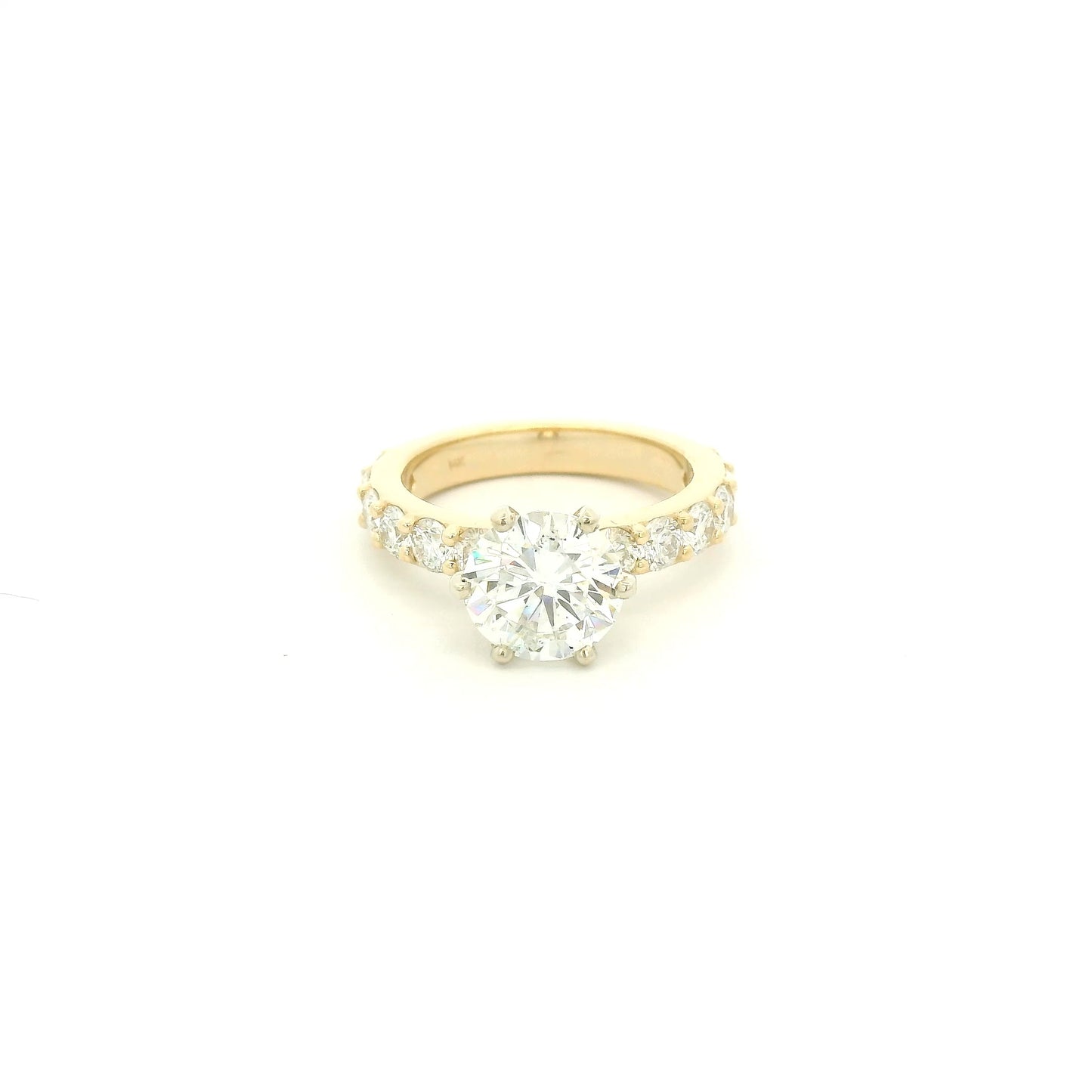 This custom 14k yellow gold engagement ring was designed around a client’s treasured diamond, creating a one-of-a-kind heirloom to be cherished for generations. The stunning 2.05 carat round brilliant cut natural diamond was professionally GIA graded as F color, VS1 clarity, and Excellent cut, polish, and symmetry (Triple Excellent) before being set into its custom-made mounting. Framing the center stone are 1.30 total carats of natural diamonds flowing down the substantial 3mm-wide band, adding brilliance 