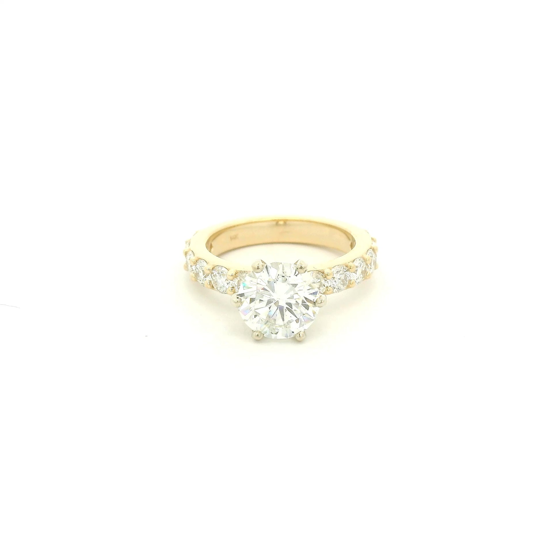 This custom 14k yellow gold engagement ring was designed around a client’s treasured diamond, creating a one-of-a-kind heirloom to be cherished for generations. The stunning 2.05 carat round brilliant cut natural diamond was professionally GIA graded as F color, VS1 clarity, and Excellent cut, polish, and symmetry (Triple Excellent) before being set into its custom-made mounting. Framing the center stone are 1.30 total carats of natural diamonds flowing down the substantial 3mm-wide band, adding brilliance 