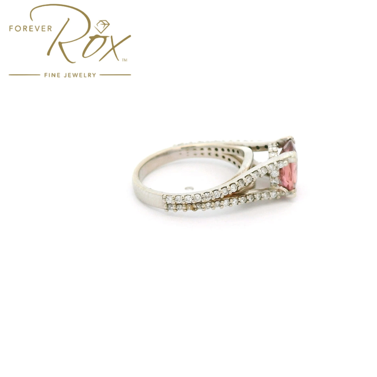 A White Gold Ring with a prong set oval cut natural AGL Certified Padparadscha Sapphire in the center wdiamond accents on the ring at Forever Rox Fine Jewelry, Lake Tahoes Best Jewelry Store
