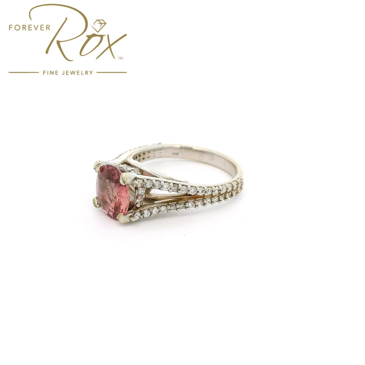 A White Gold Ring with a prong set oval cut natural AGL Certified Padparadscha Sapphire in the center wdiamond accents on the ring at Forever Rox Fine Jewelry, Lake Tahoes Best Jewelry Store
