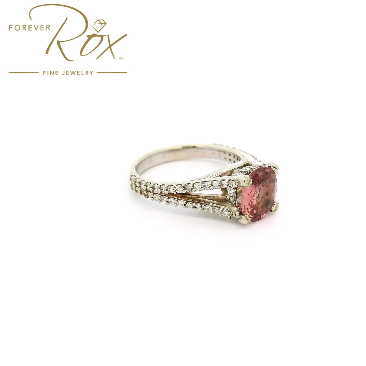 A White Gold Ring with a prong set oval cut natural AGL Certified Padparadscha Sapphire in the center wdiamond accents on the ring at Forever Rox Fine Jewelry, Lake Tahoes Best Jewelry Store

