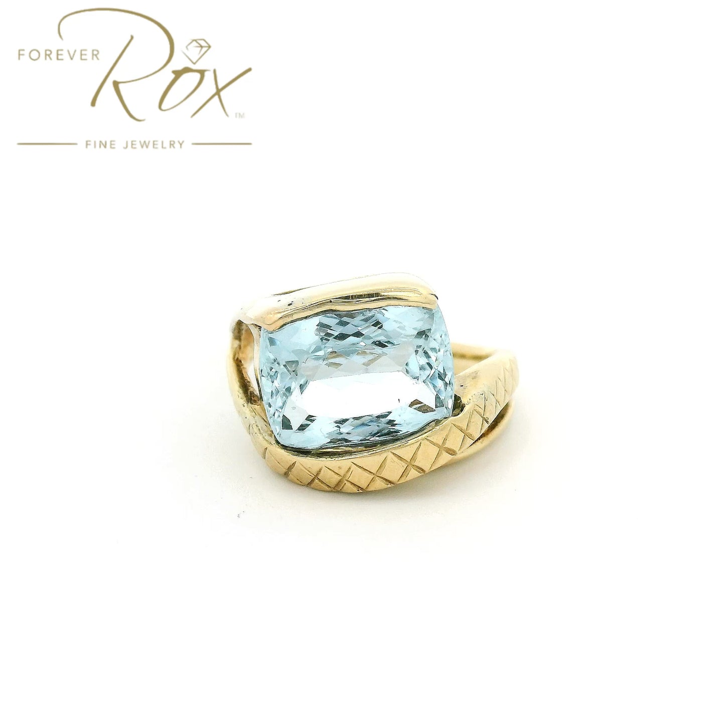 Yellow Gold ring with light blue aquamarine stone set in center and hand carved band at Forever Rox Fine Jewelry 