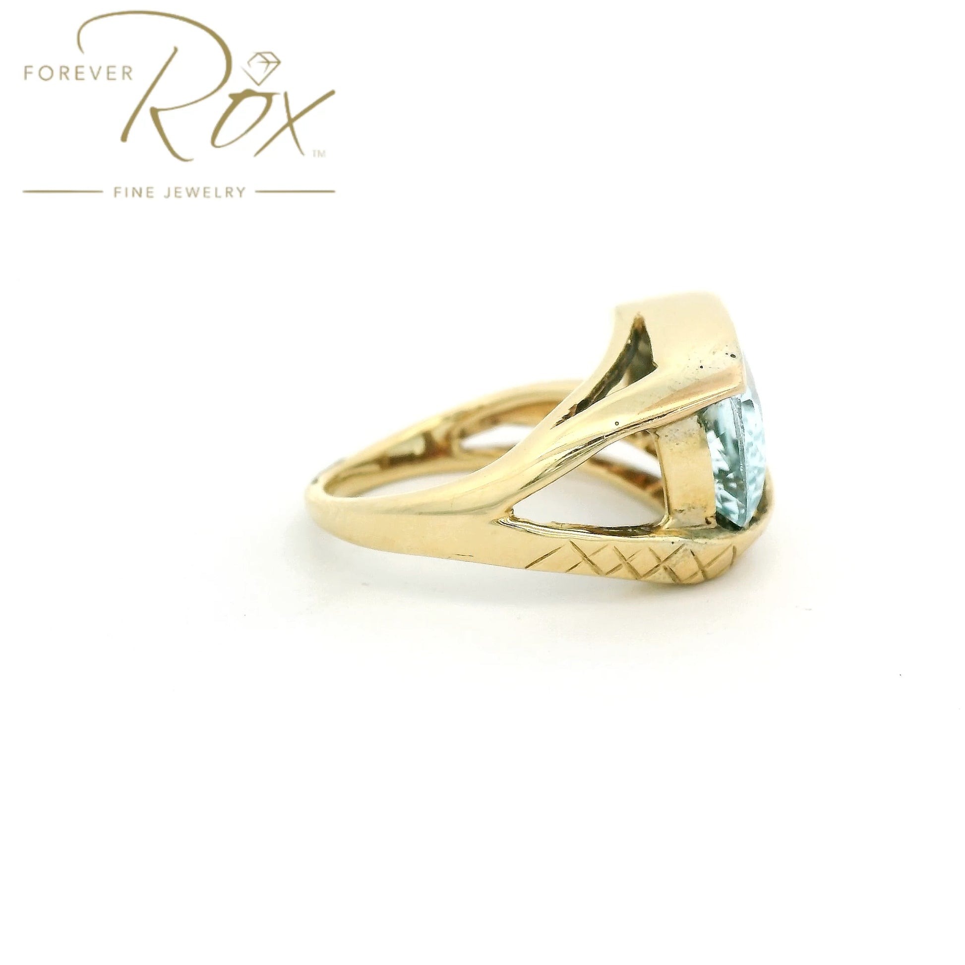 Yellow Gold ring with light blue aquamarine stone set in center and hand carved band at Forever Rox Fine Jewelry 