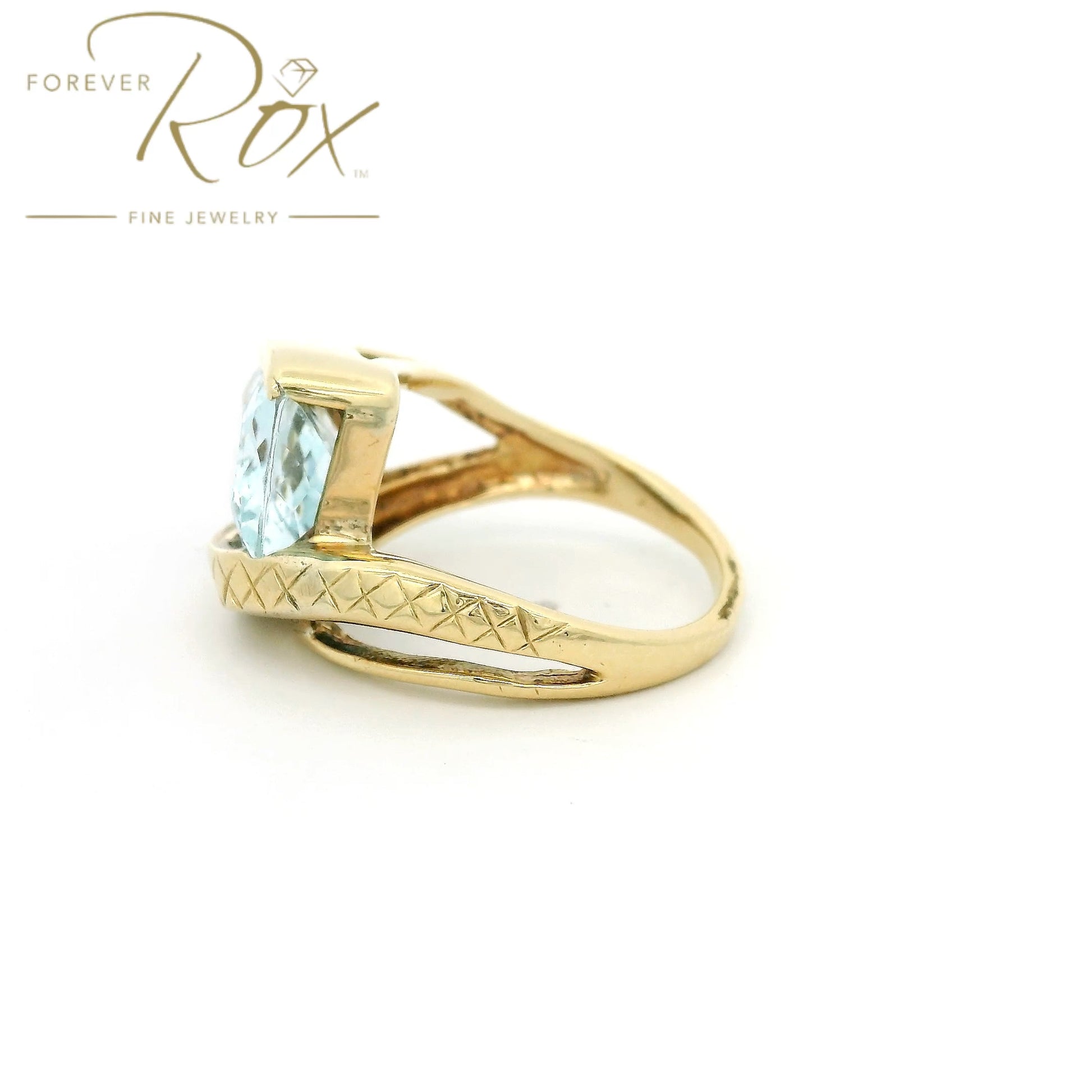 Yellow Gold ring with light blue aquamarine stone set in center and hand carved band at Forever Rox Fine Jewelry 