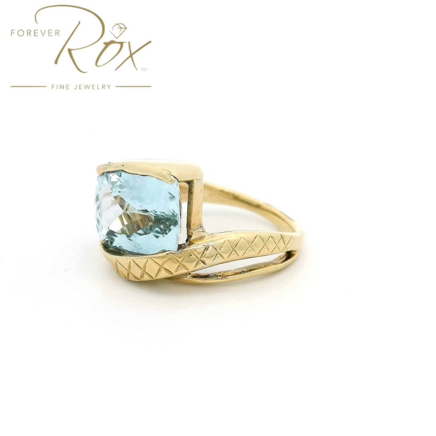 Yellow Gold ring with light blue aquamarine stone set in center and hand carved band at Forever Rox Fine Jewelry 