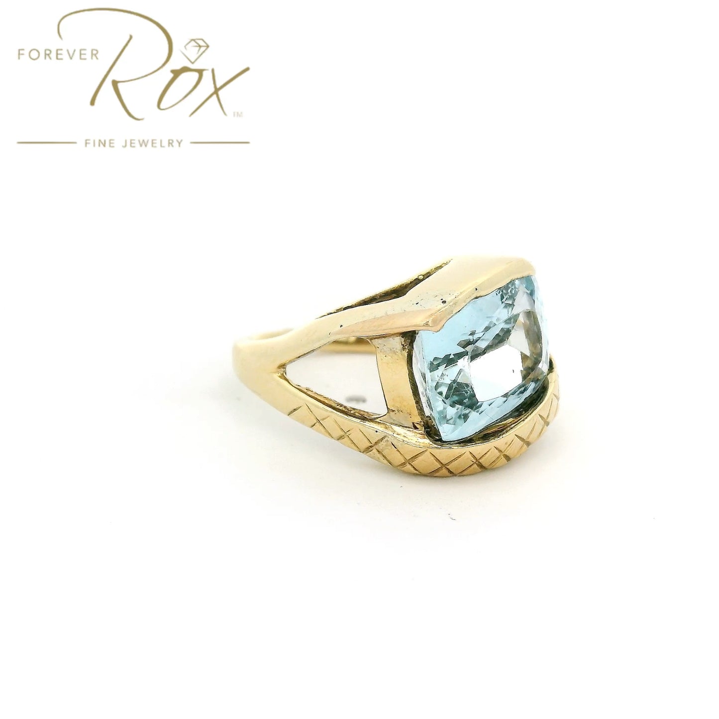 Yellow Gold ring with light blue aquamarine stone set in center and hand carved band at Forever Rox Fine Jewelry 