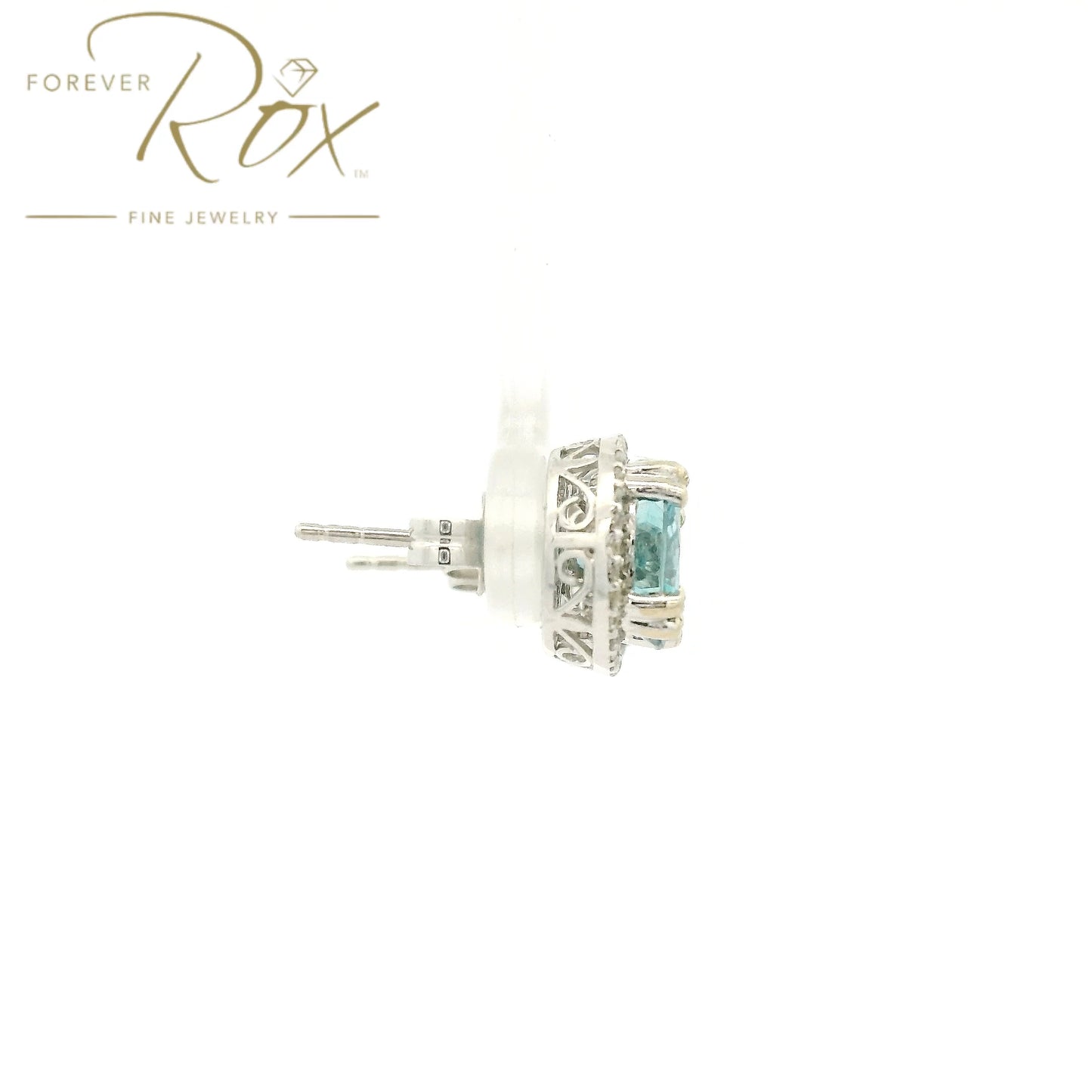 A Pair of White Gold Earrings with prong set round cut natural Blue Zircon in the center with a diamond halo at Forever Rox Fine Jewelry, Lake Tahoes Best Jewelry Store
