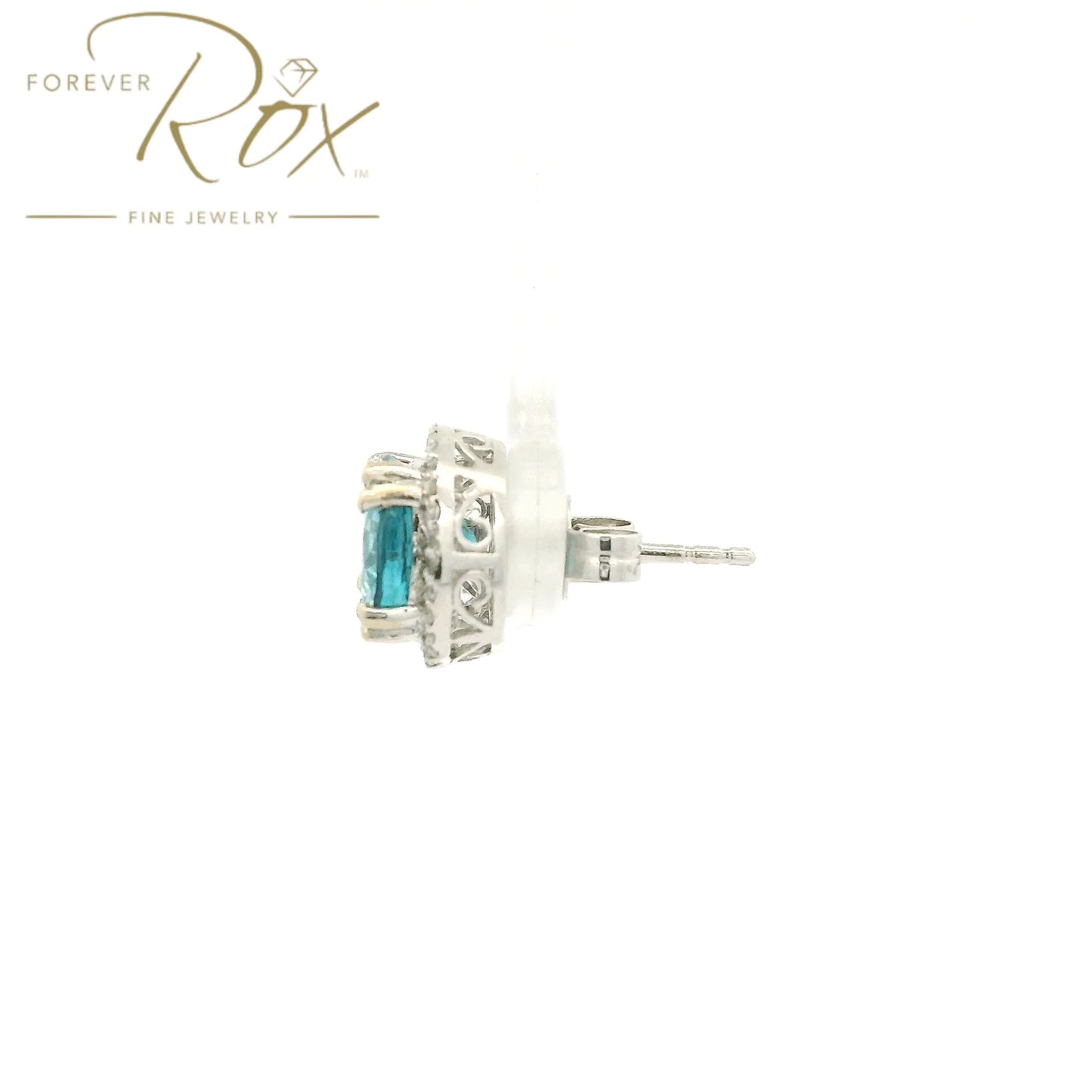 A Pair of White Gold Earrings with prong set round cut natural Blue Zircon in the center with a diamond halo at Forever Rox Fine Jewelry, Lake Tahoes Best Jewelry Store