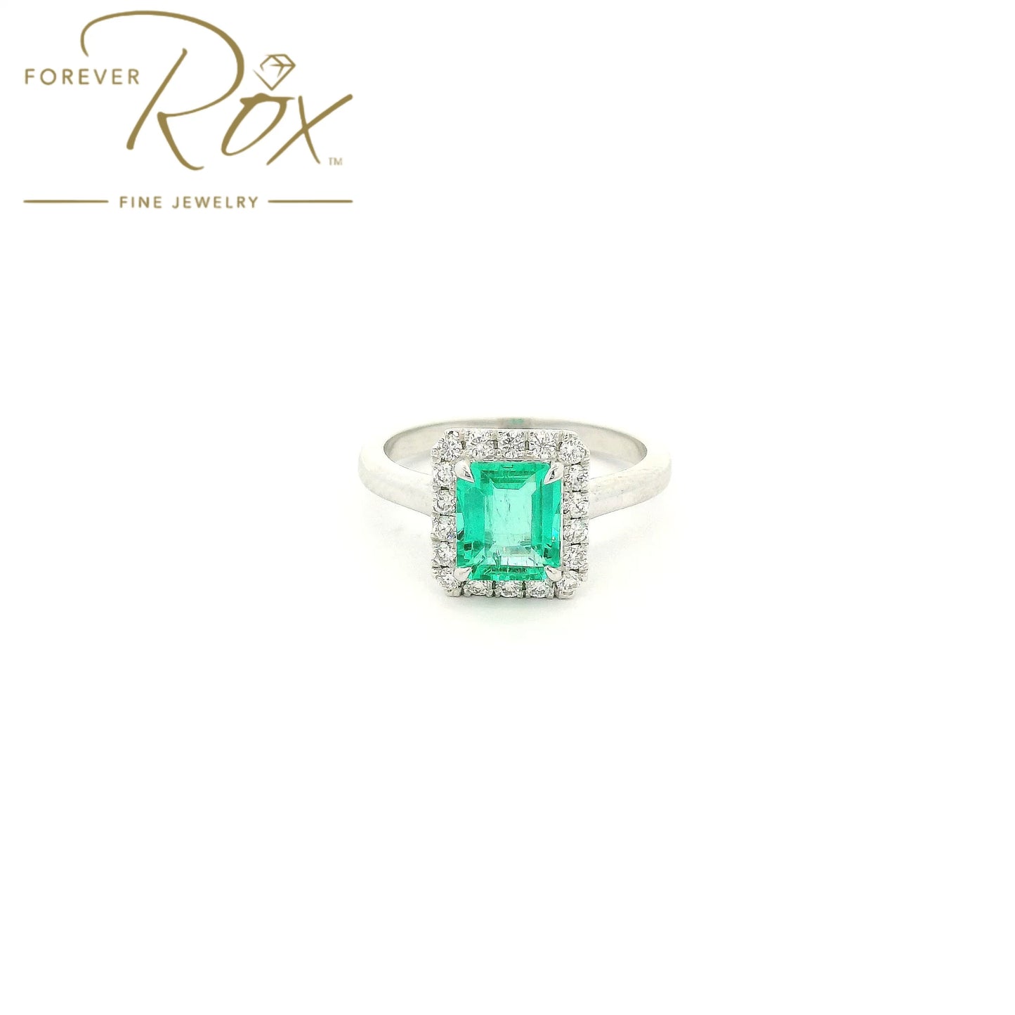 Custom 14k white gold ring featuring a 1.05ct emerald-cut Colombian emerald with a 0.22ctw diamond halo by Forever Rox Fine Jewelry, Lake Tahoes Best Jewelry Store