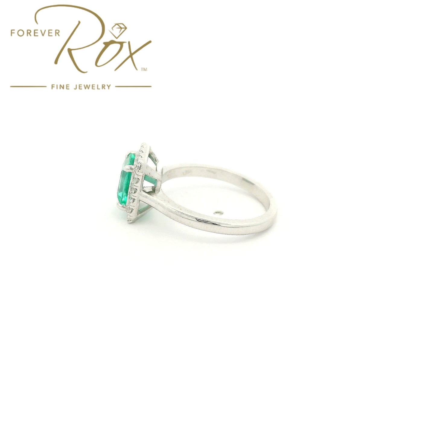 Custom 14k white gold ring featuring a 1.05ct emerald-cut Colombian emerald with a 0.22ctw diamond halo by Forever Rox Fine Jewelry, Lake Tahoes Best Jewelry Store