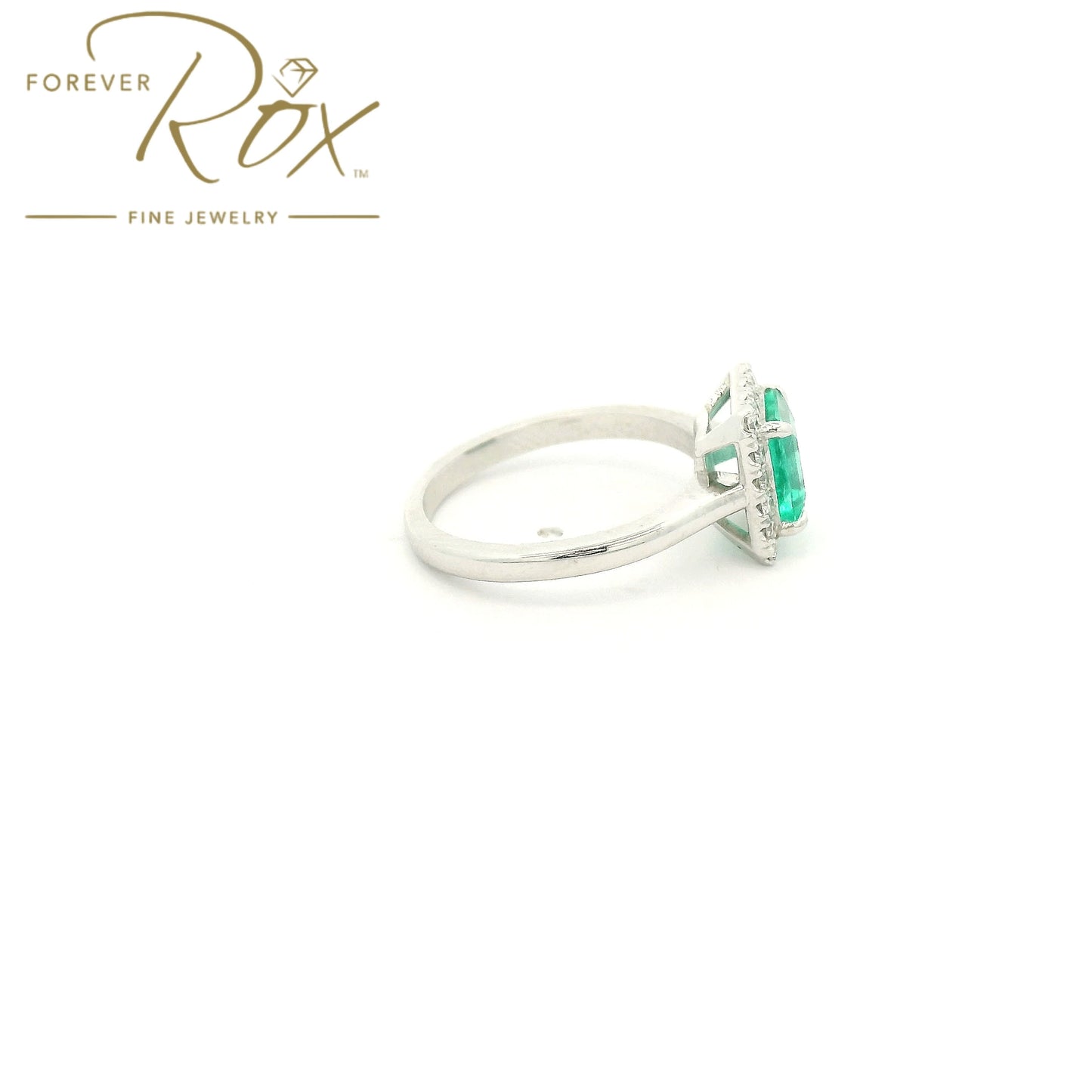 Custom 14k white gold ring featuring a 1.05ct emerald-cut Colombian emerald with a 0.22ctw diamond halo by Forever Rox Fine Jewelry, Lake Tahoes Best Jewelry Store