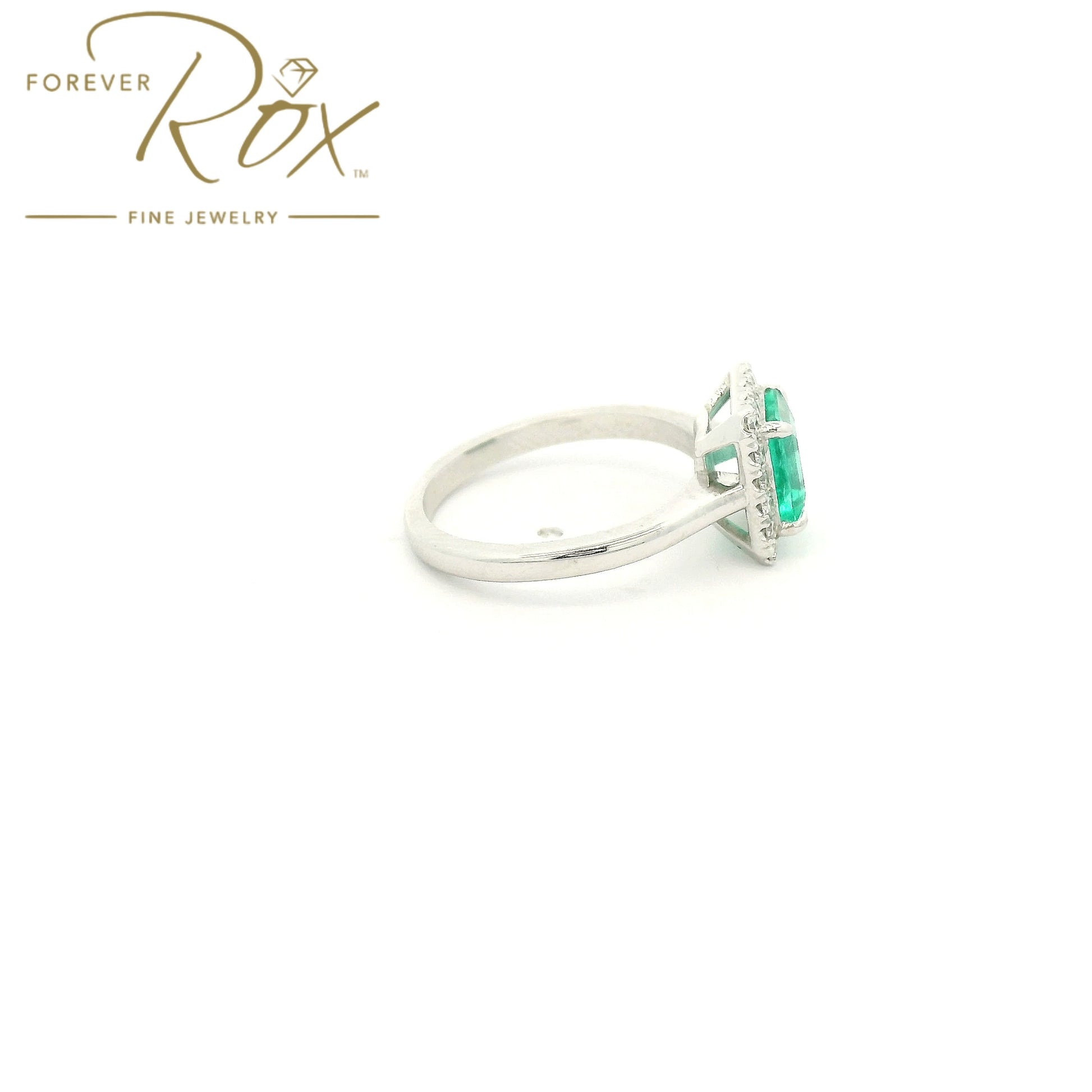 Custom 14k white gold ring featuring a 1.05ct emerald-cut Colombian emerald with a 0.22ctw diamond halo by Forever Rox Fine Jewelry, Lake Tahoes Best Jewelry Store