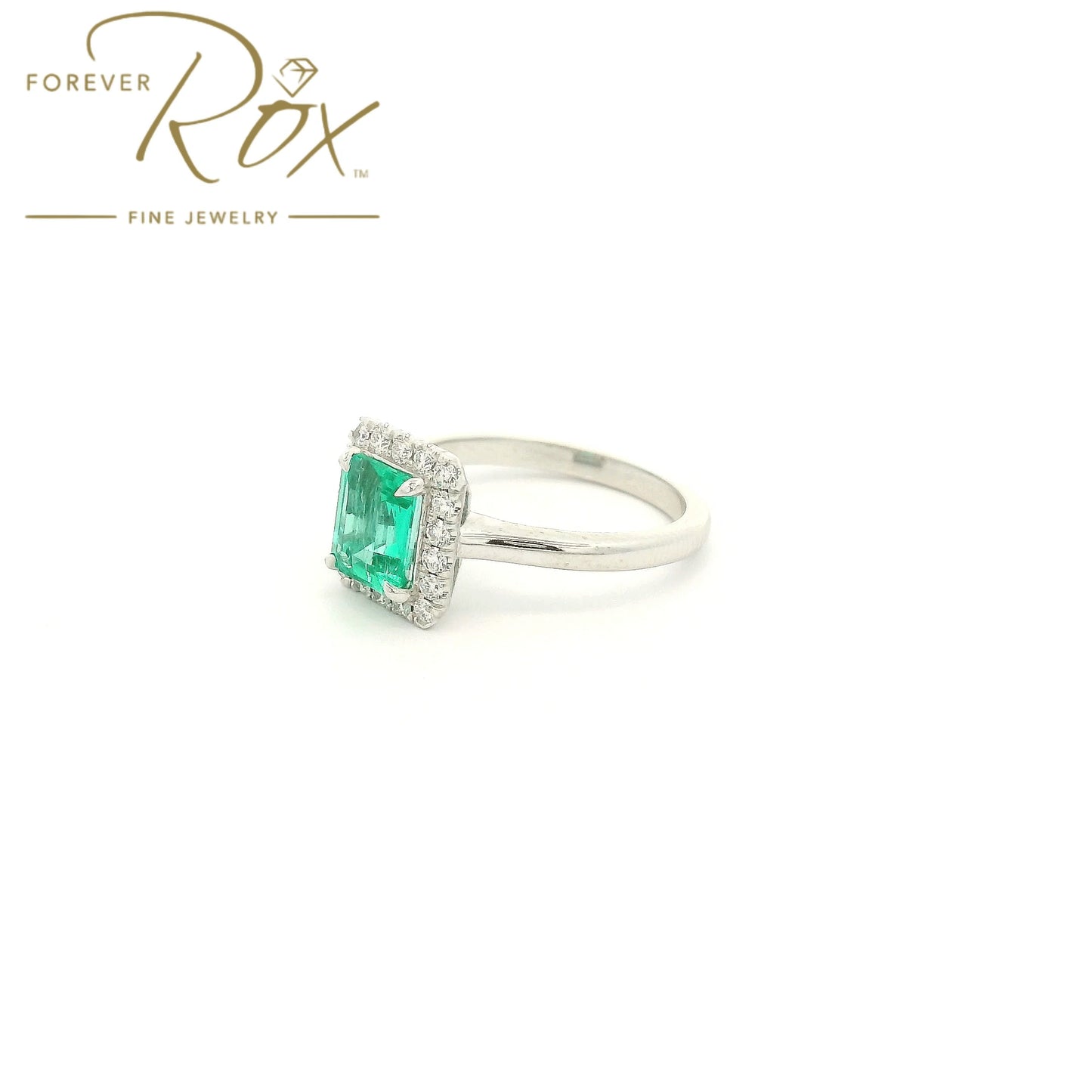 Custom 14k white gold ring featuring a 1.05ct emerald-cut Colombian emerald with a 0.22ctw diamond halo by Forever Rox Fine Jewelry, Lake Tahoes Best Jewelry Store